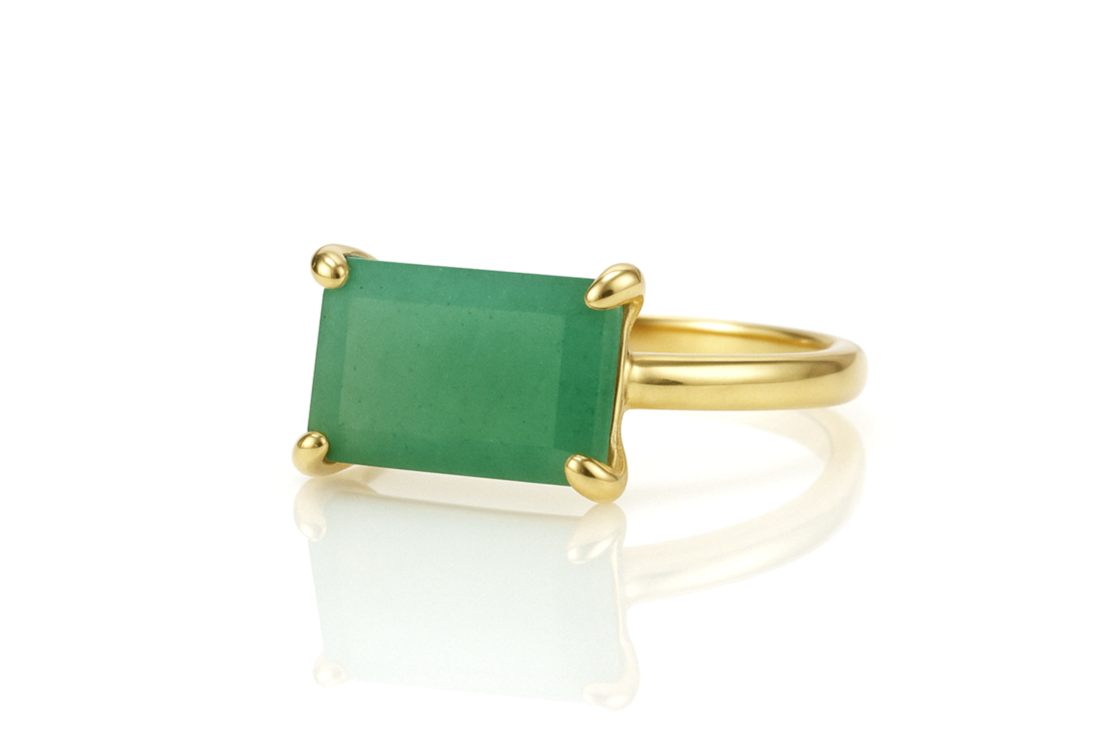 a gold ring with a green stone on it