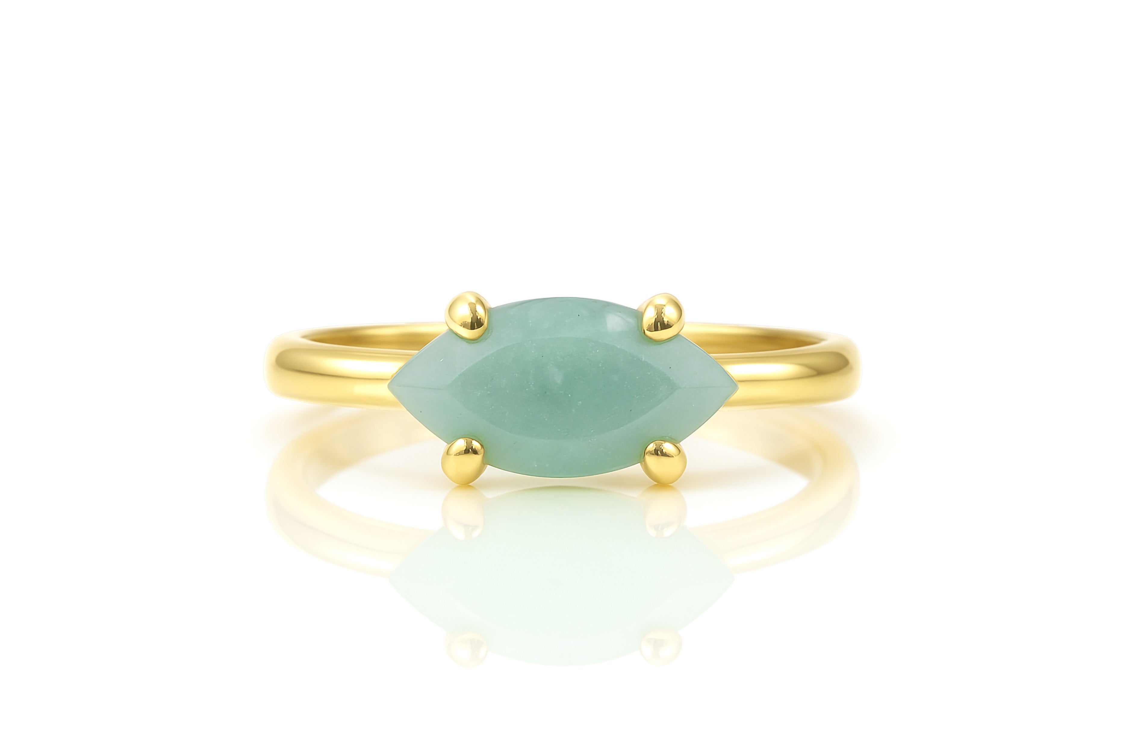 a gold ring with a green stone on it