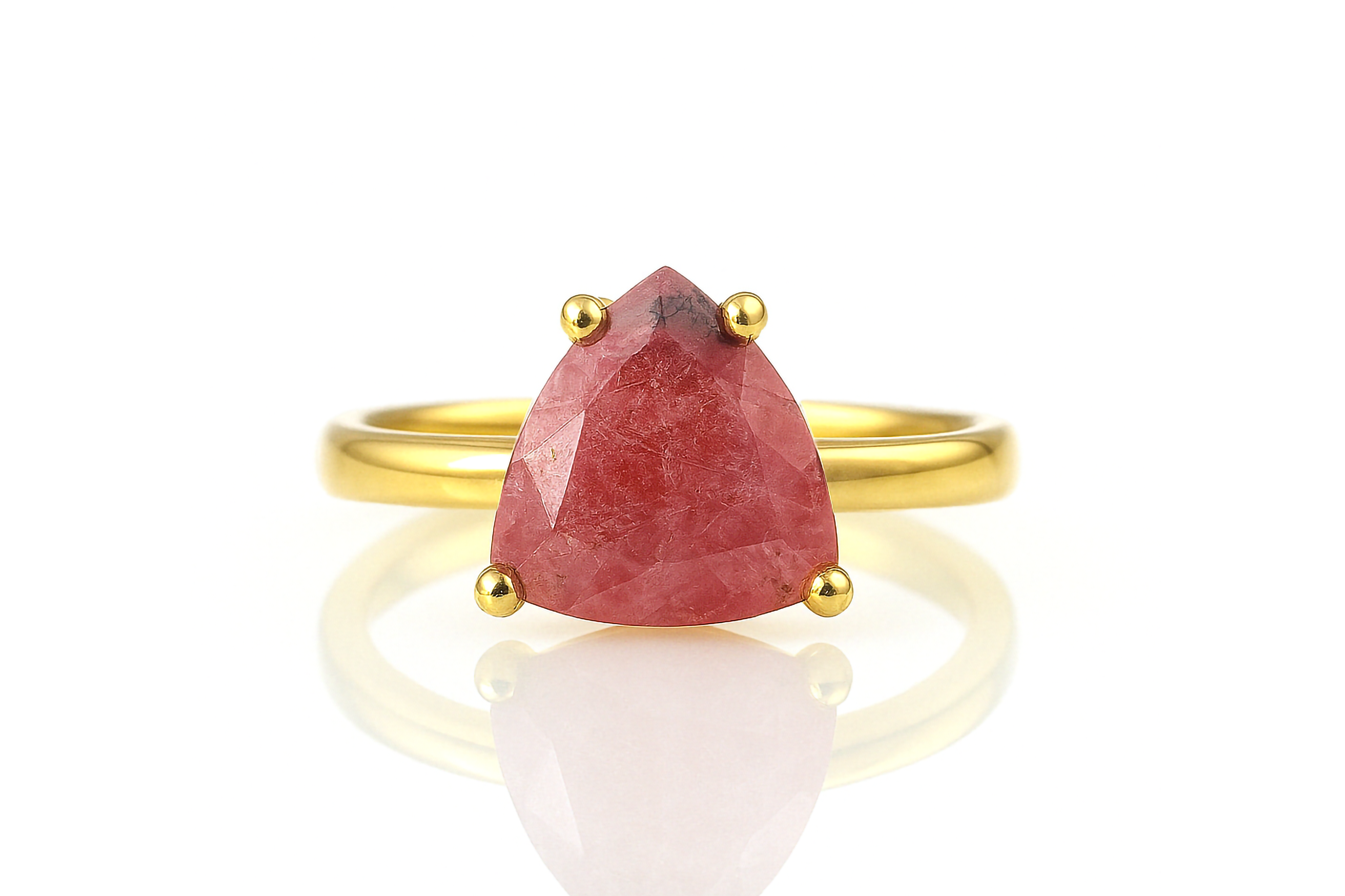 a yellow gold ring with a red stone