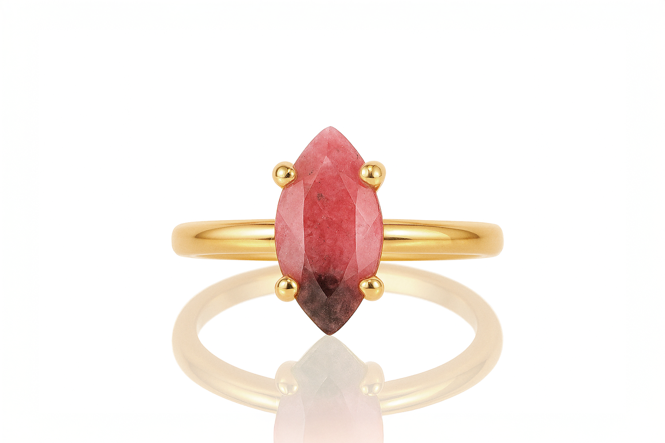 a gold ring with a red stone on it