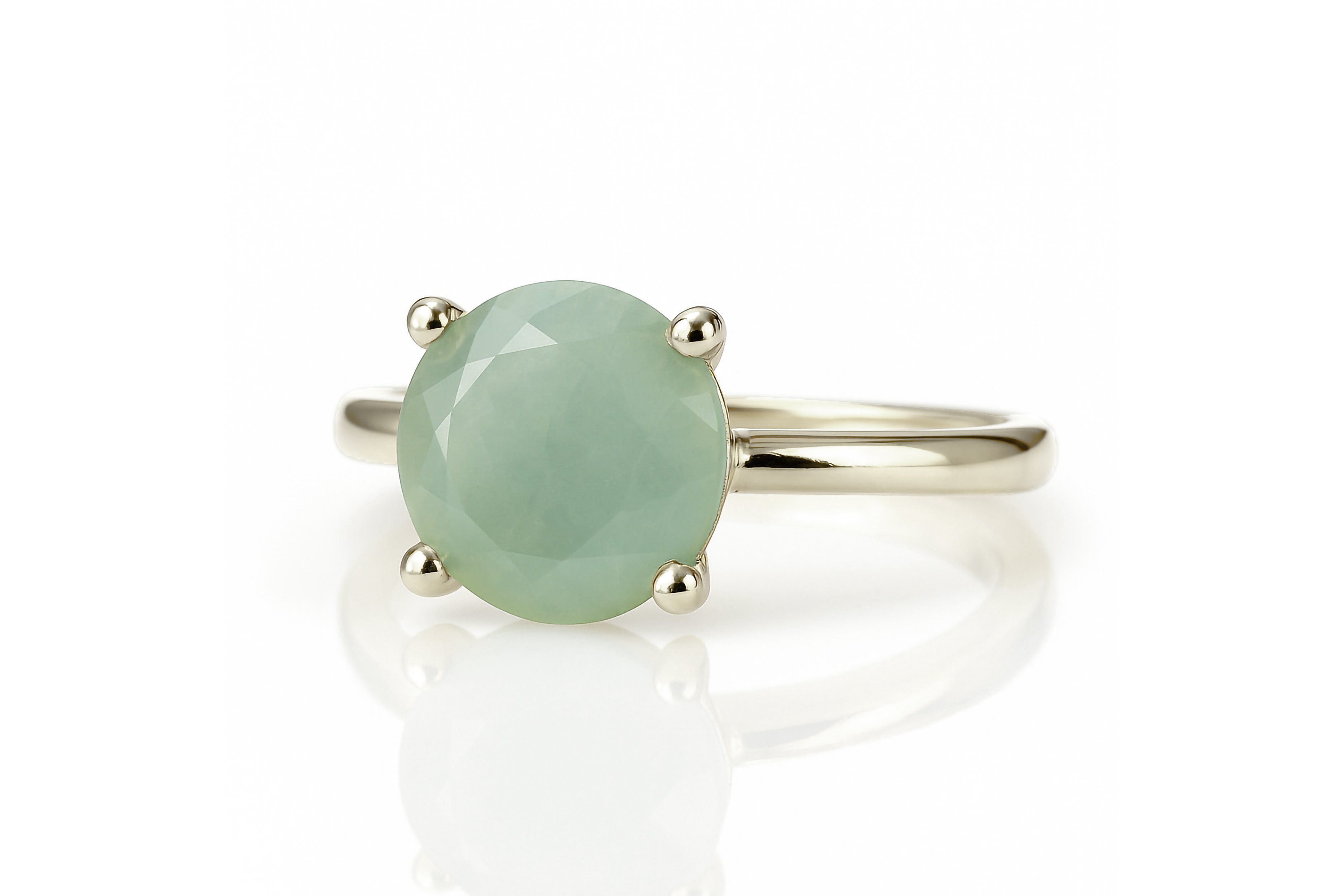 a ring with a green stone on top of it