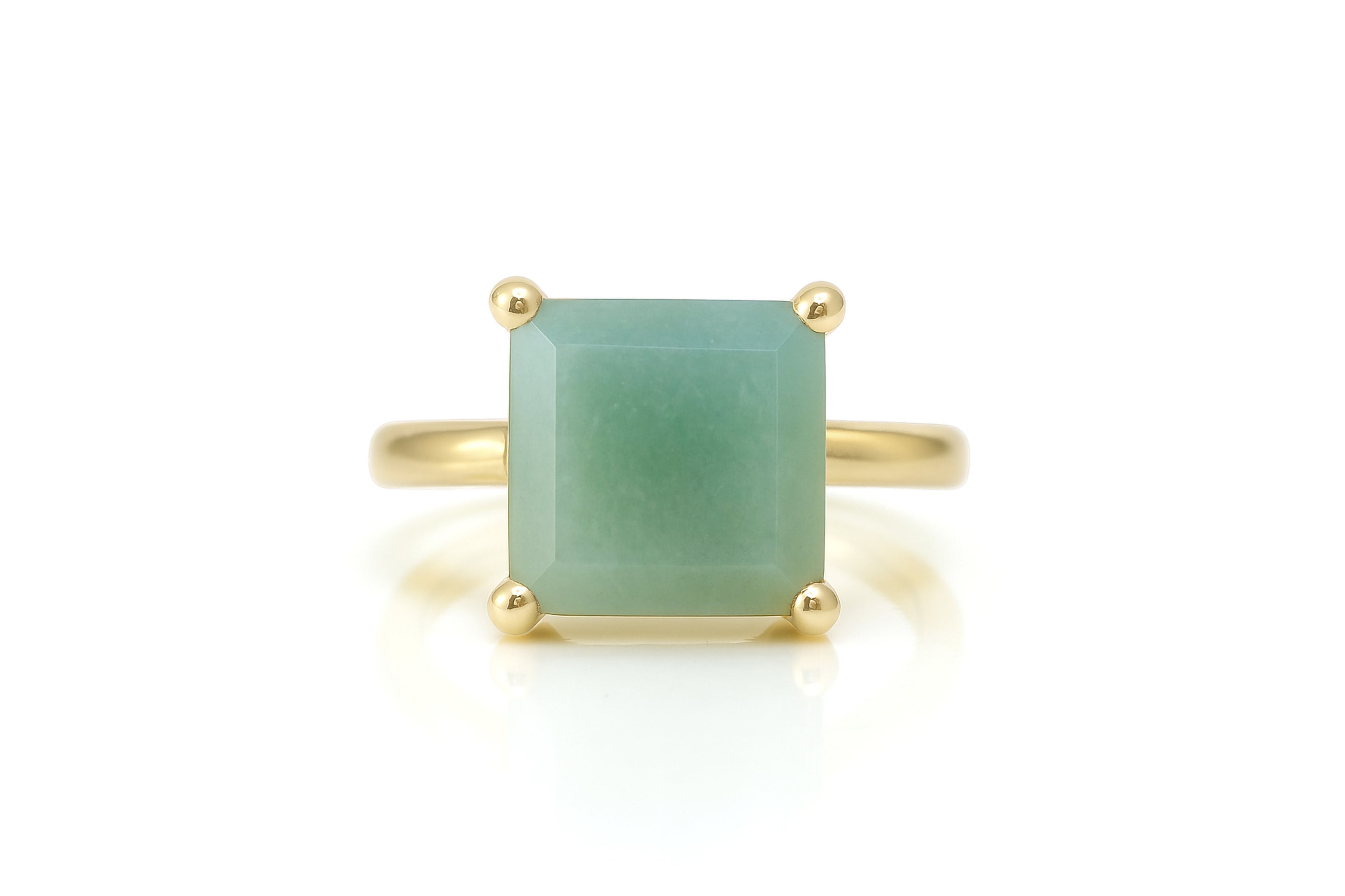 a gold ring with a green jade stone