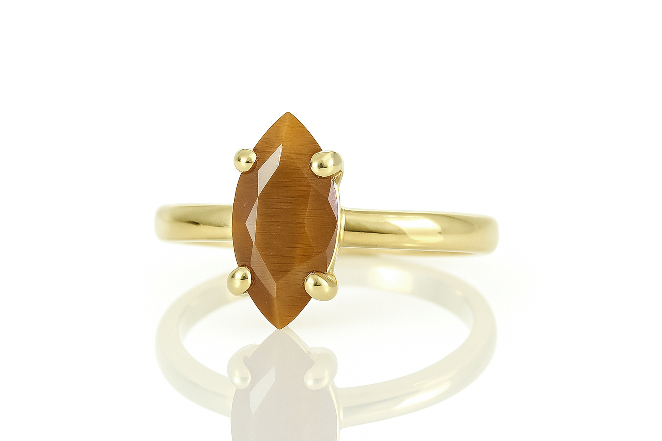 a yellow gold ring with an orange stone