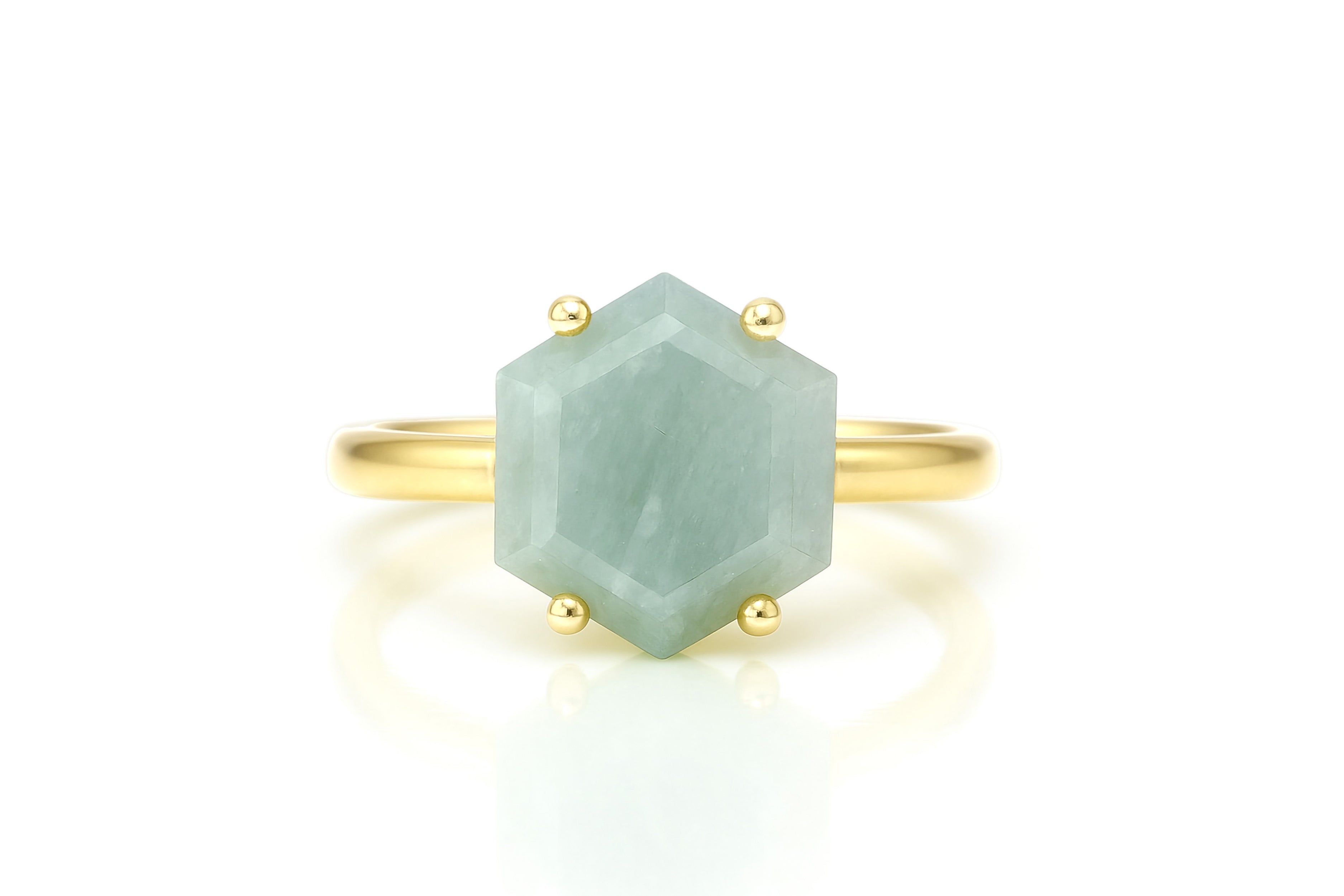 a gold ring with a green stone on it