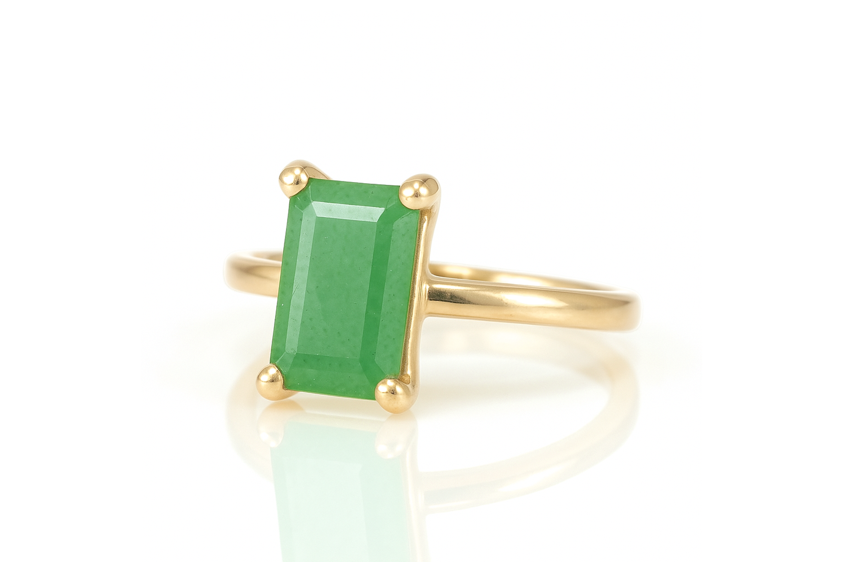 a gold ring with an emerald stone