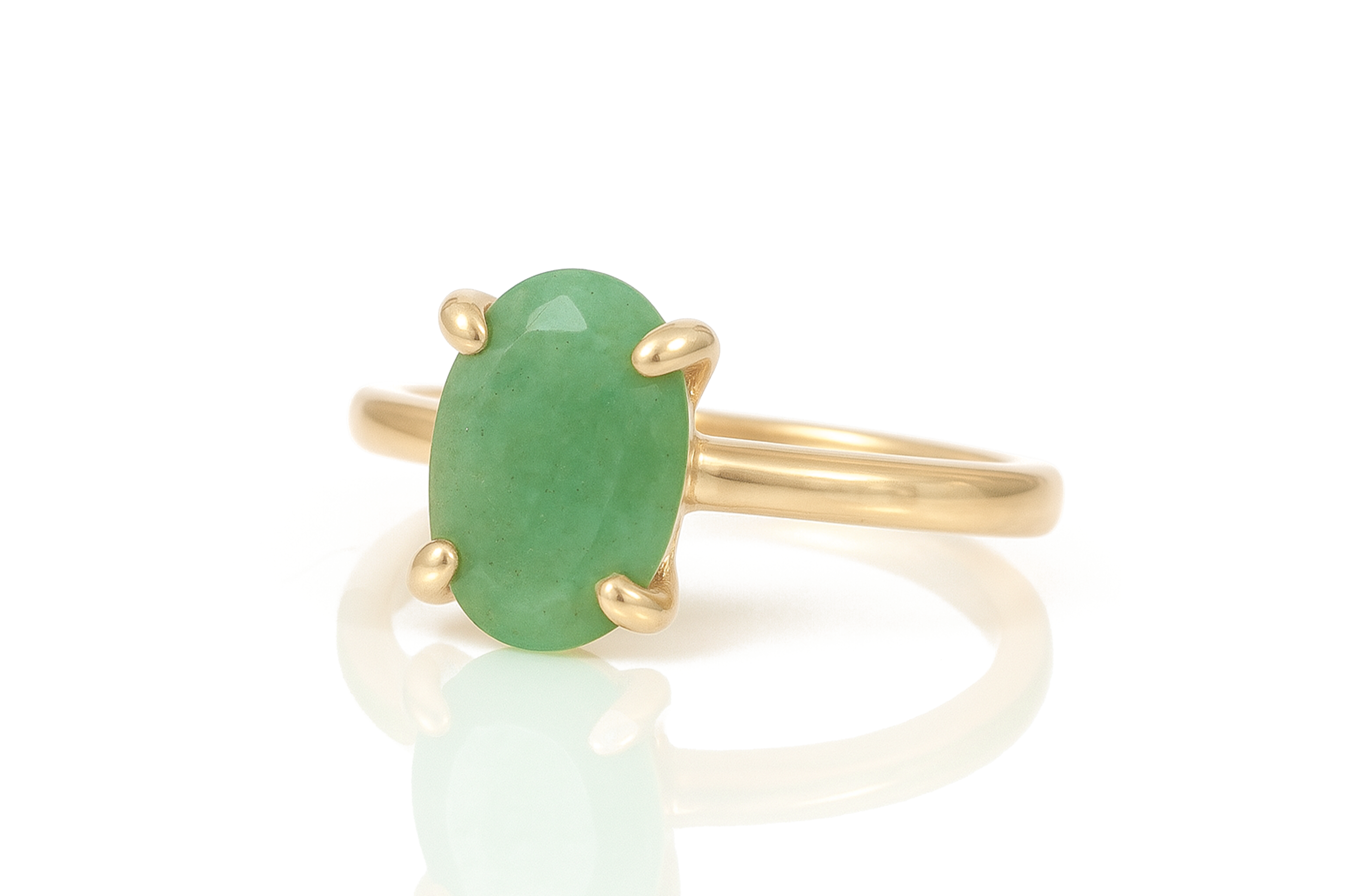 a gold ring with a green stone on it