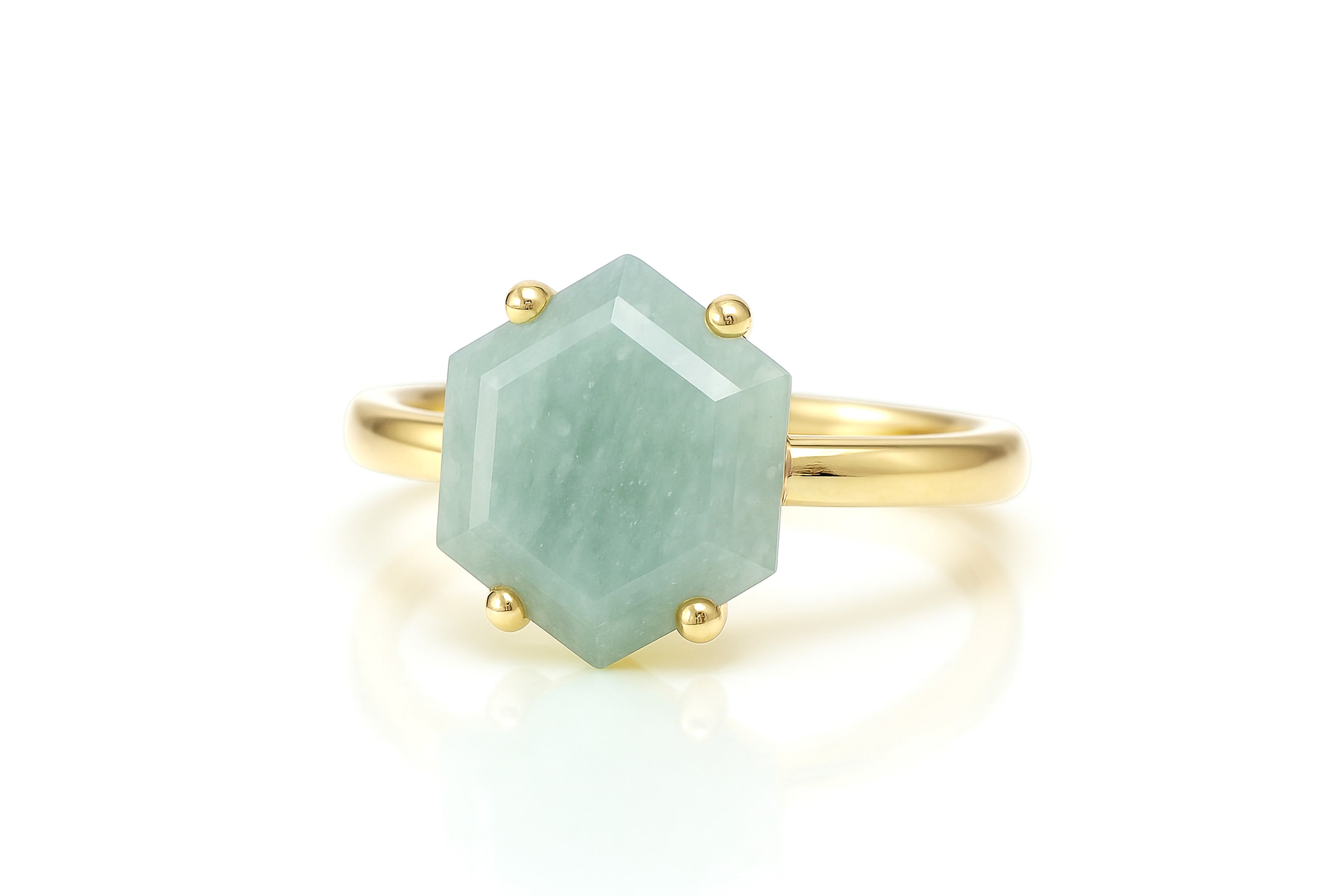 a gold ring with a green stone on it