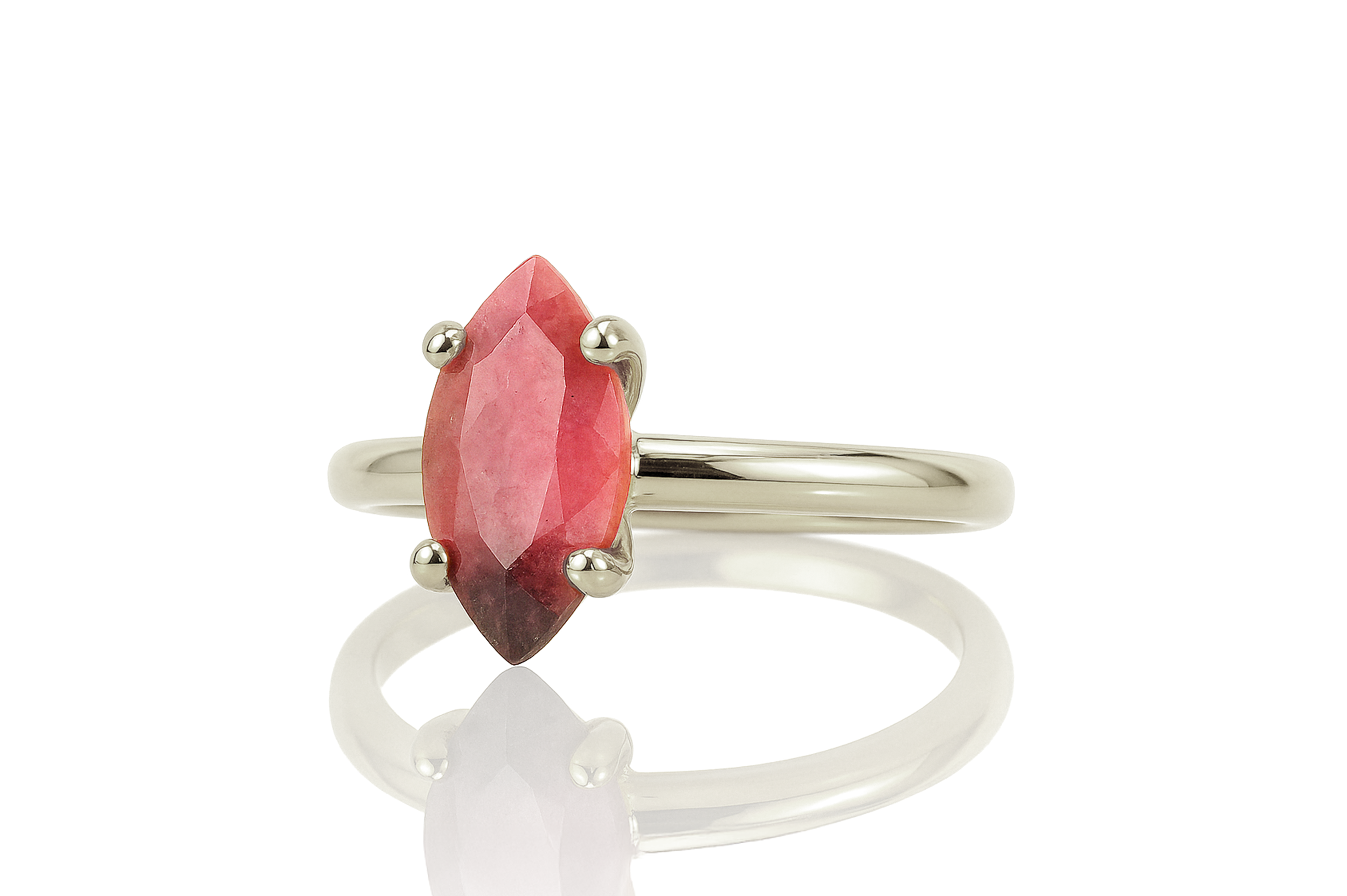 a close up of a ring with a red stone