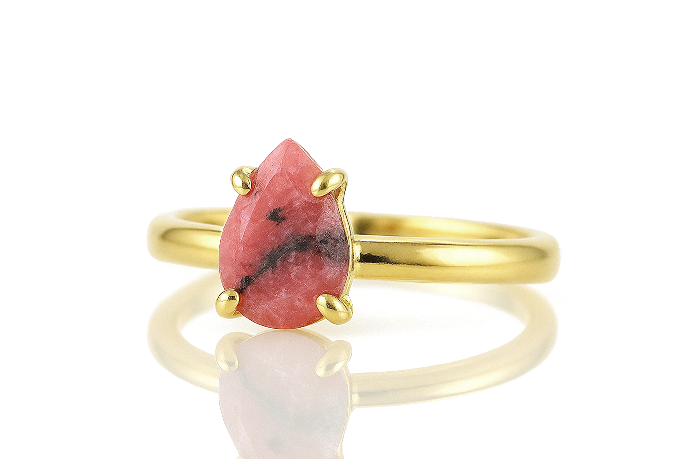 a gold ring with a red stone on it