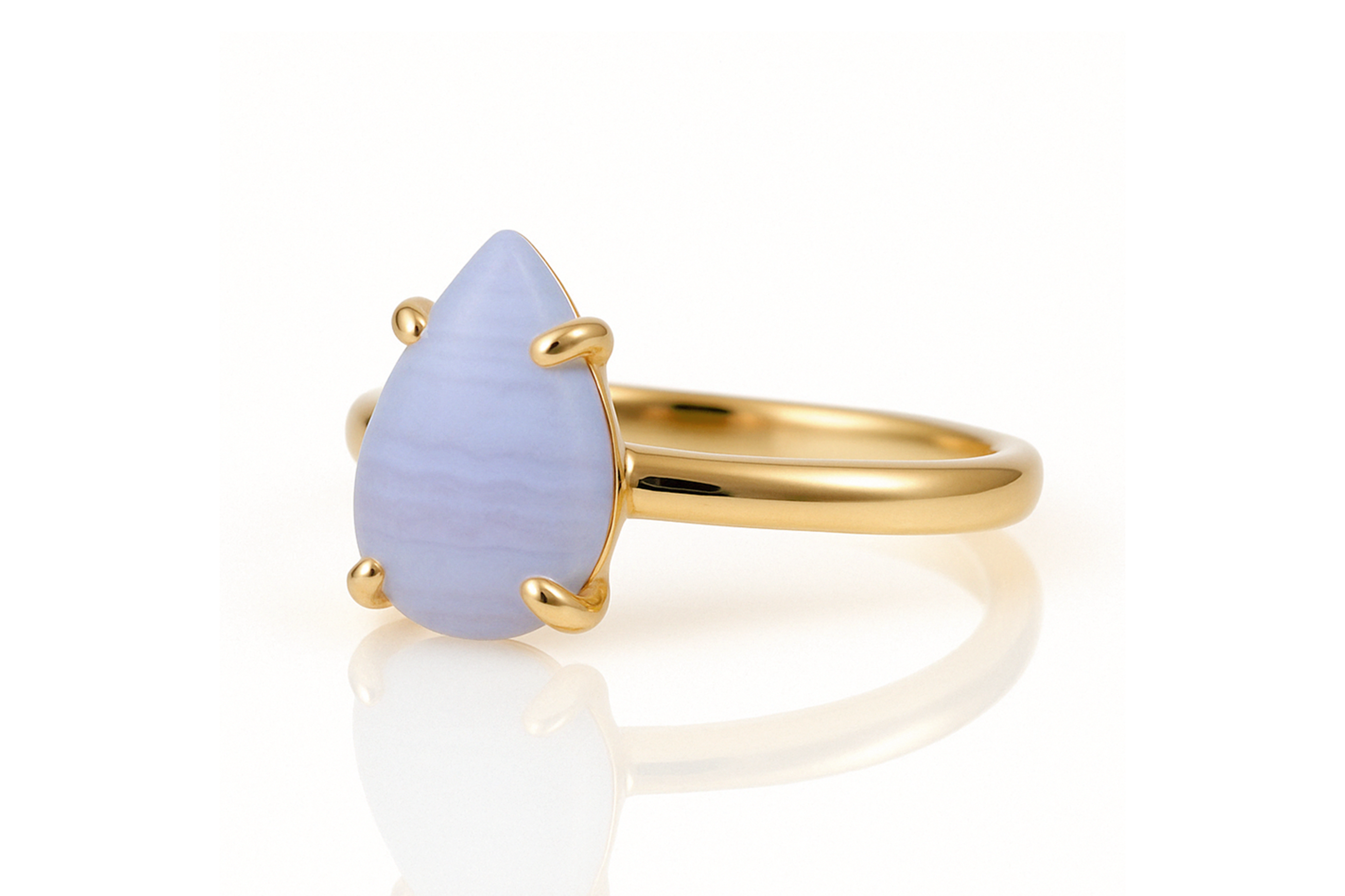 a yellow gold ring with a blue stone