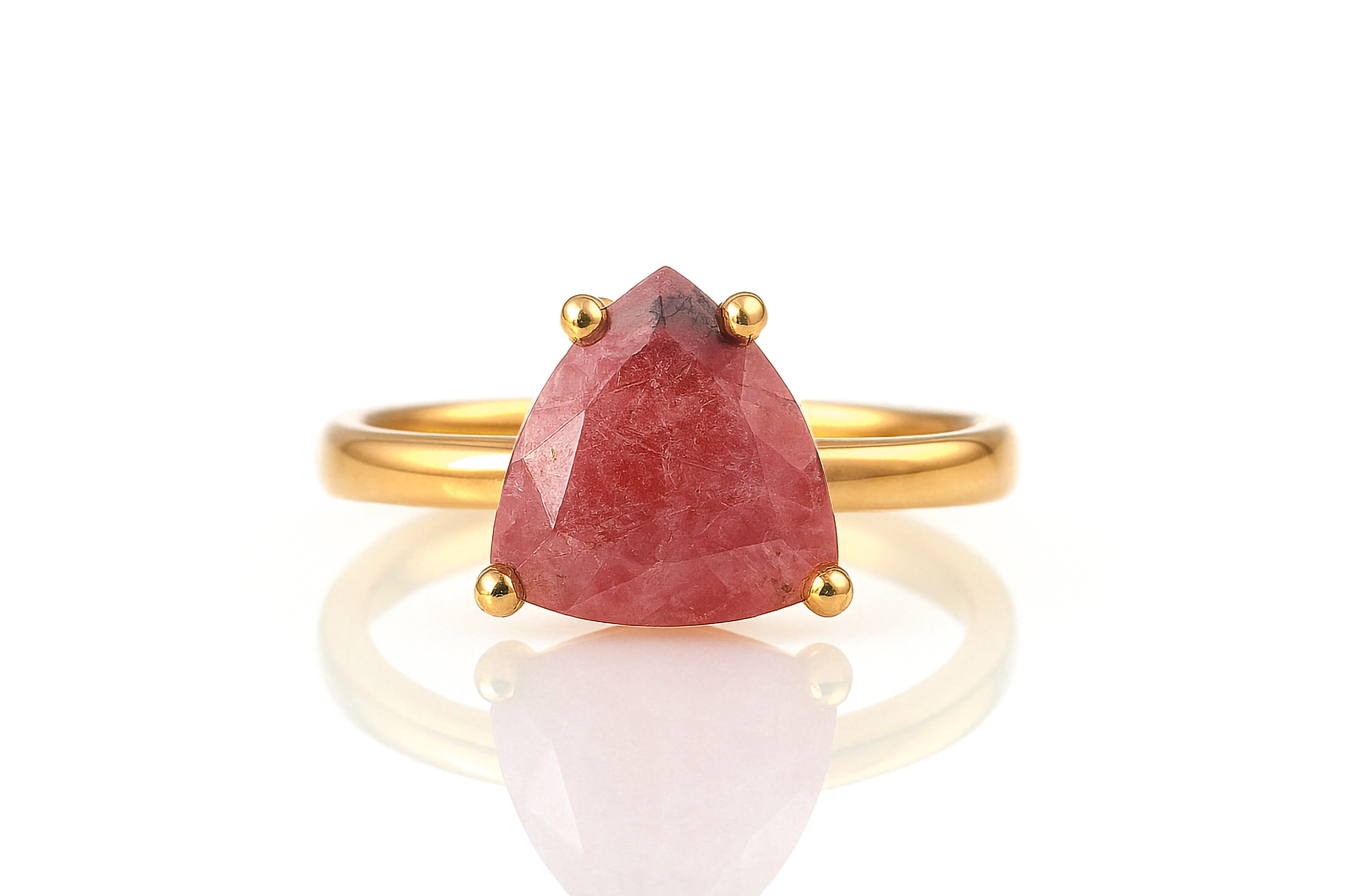 a gold ring with a red stone on it