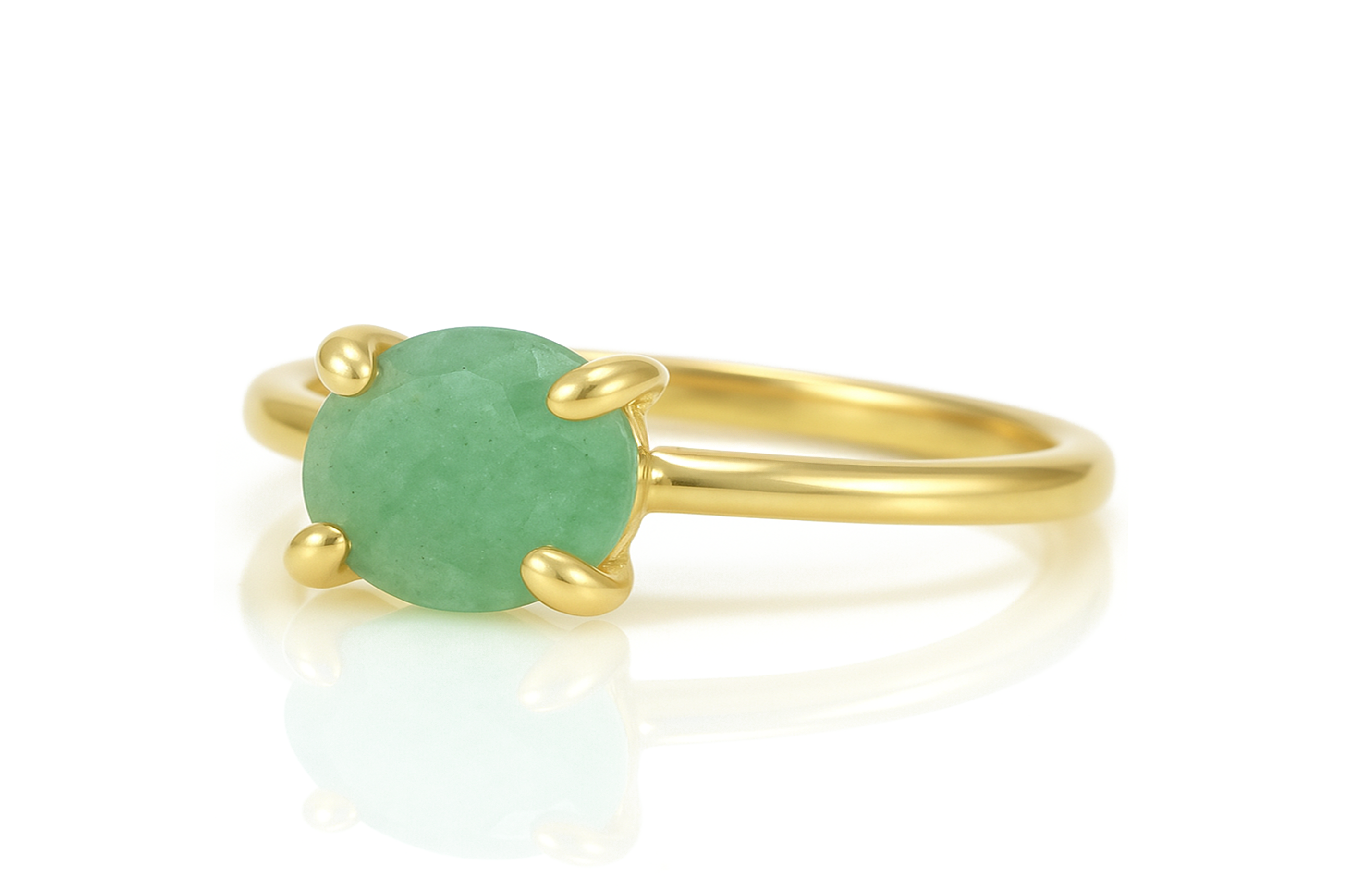 a gold ring with a green stone on it