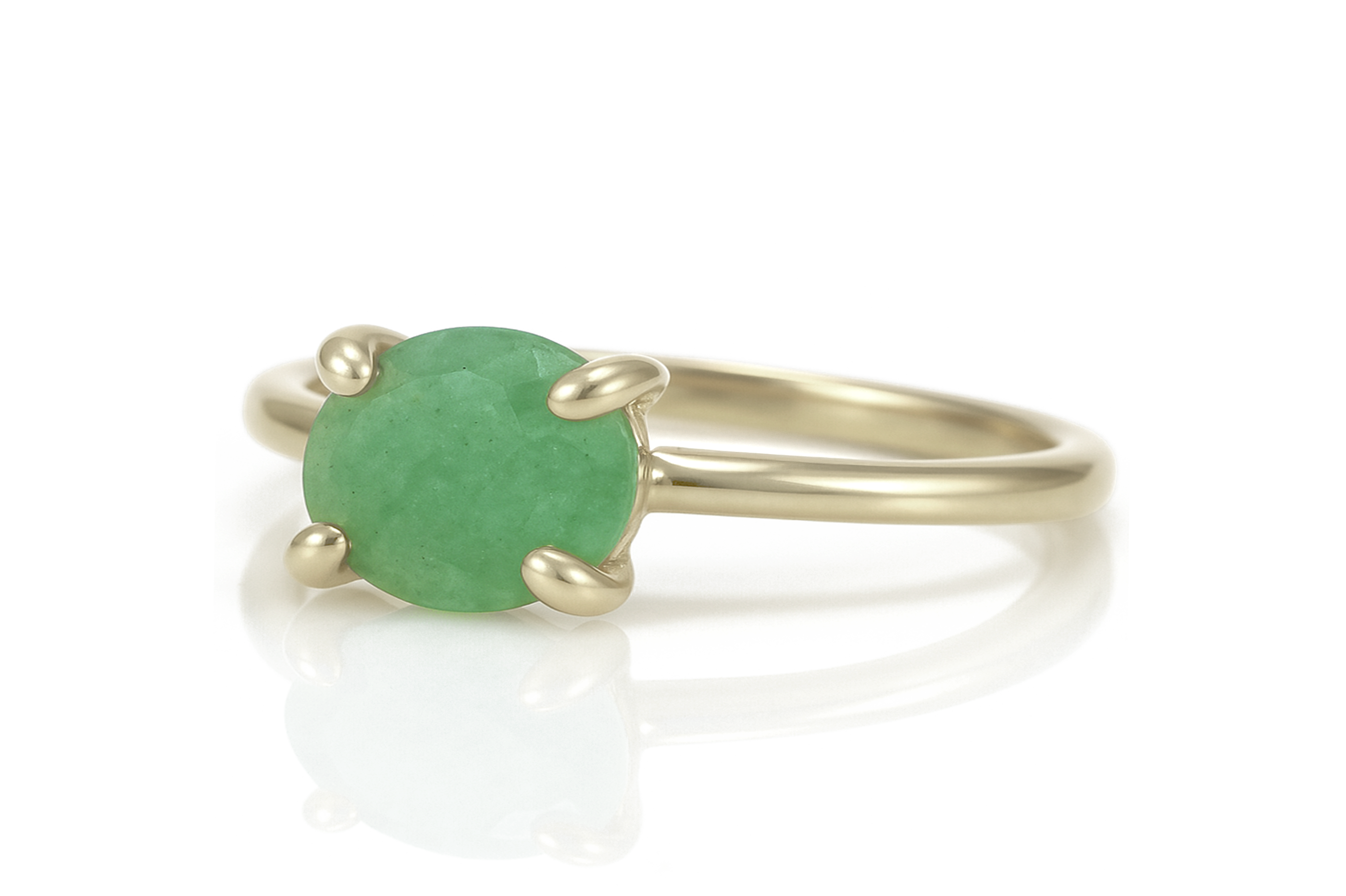 a yellow gold ring with a green stone