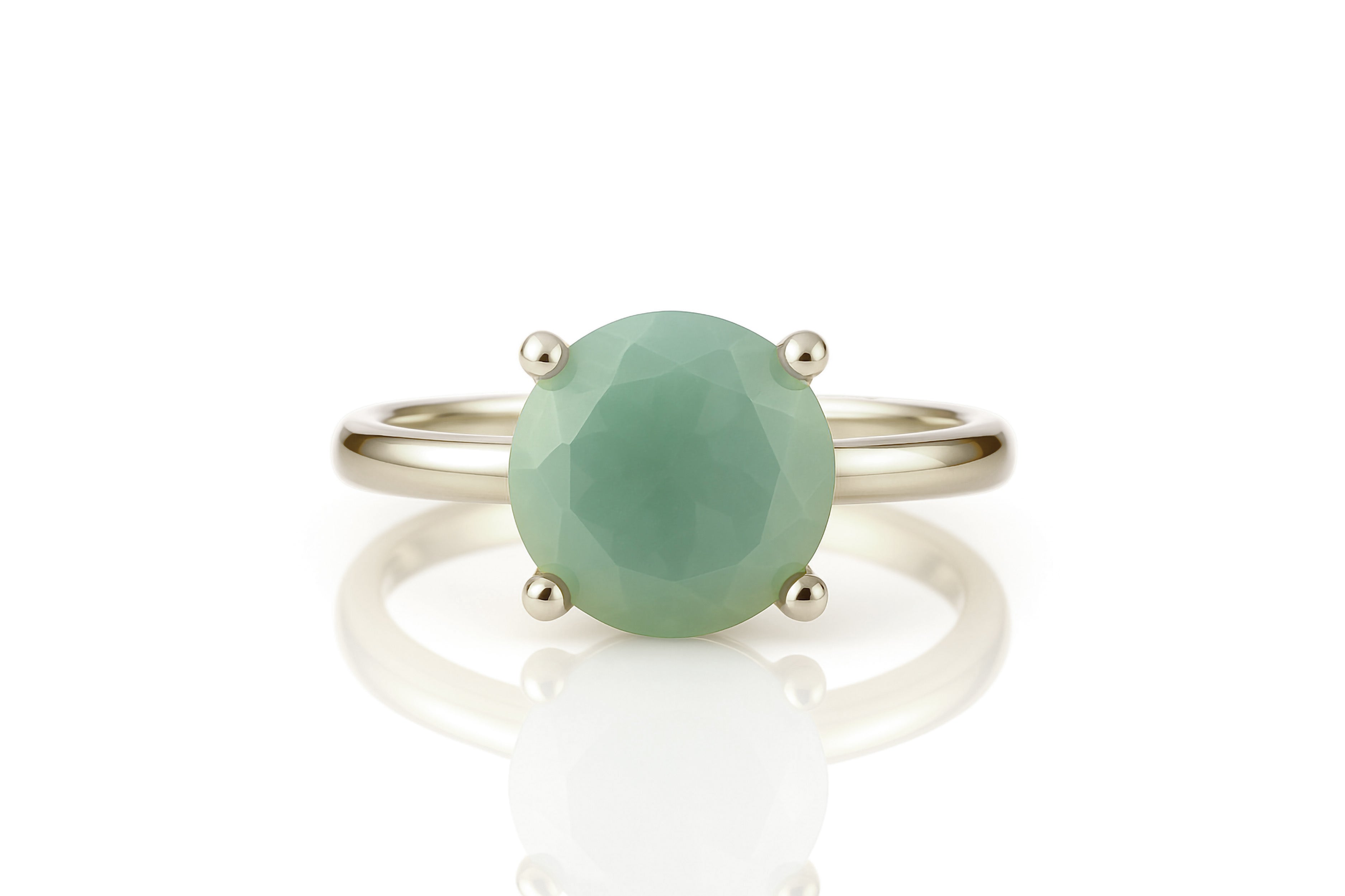 a ring with a green stone on top of it
