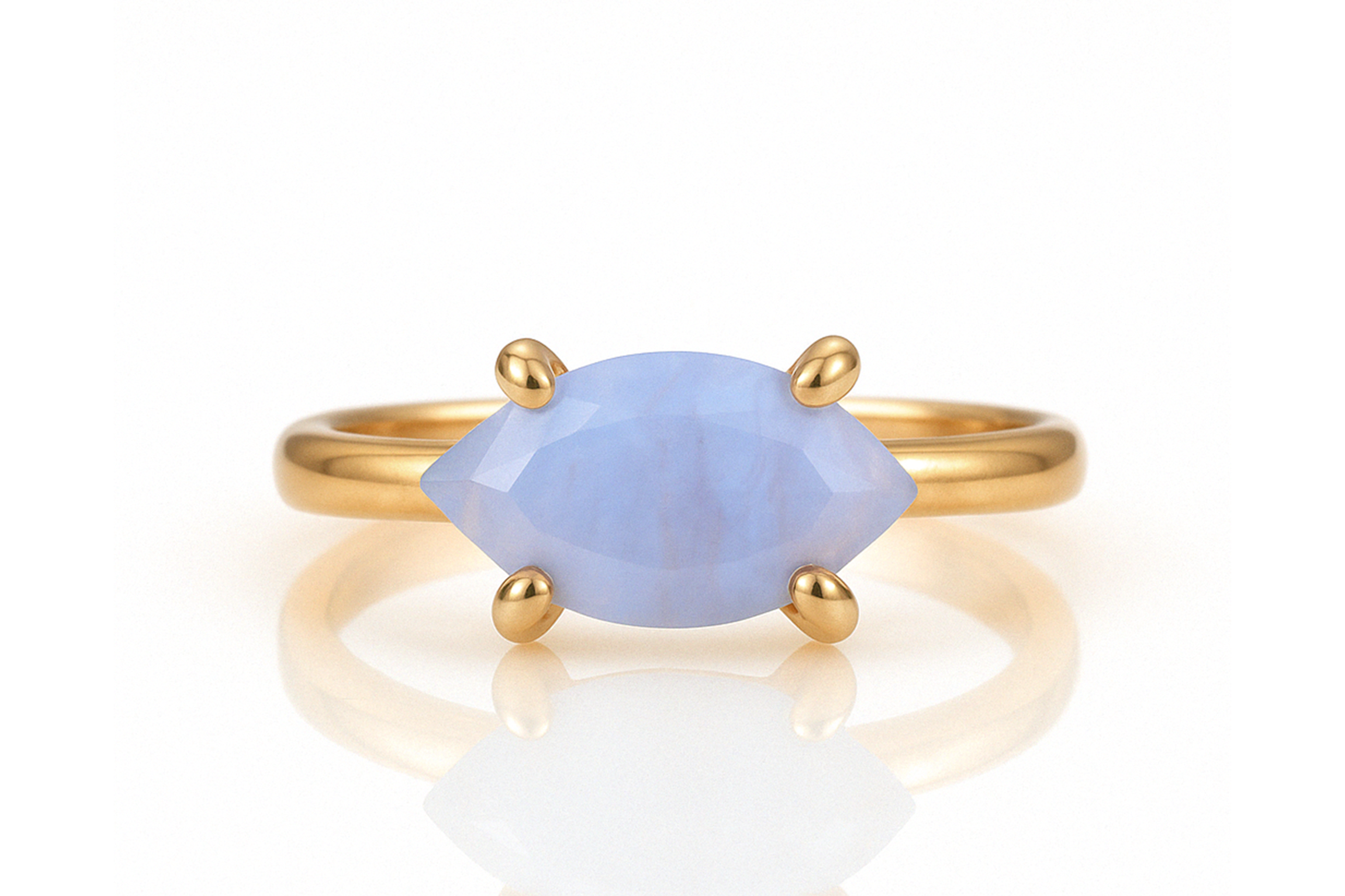 a gold ring with a blue stone on it