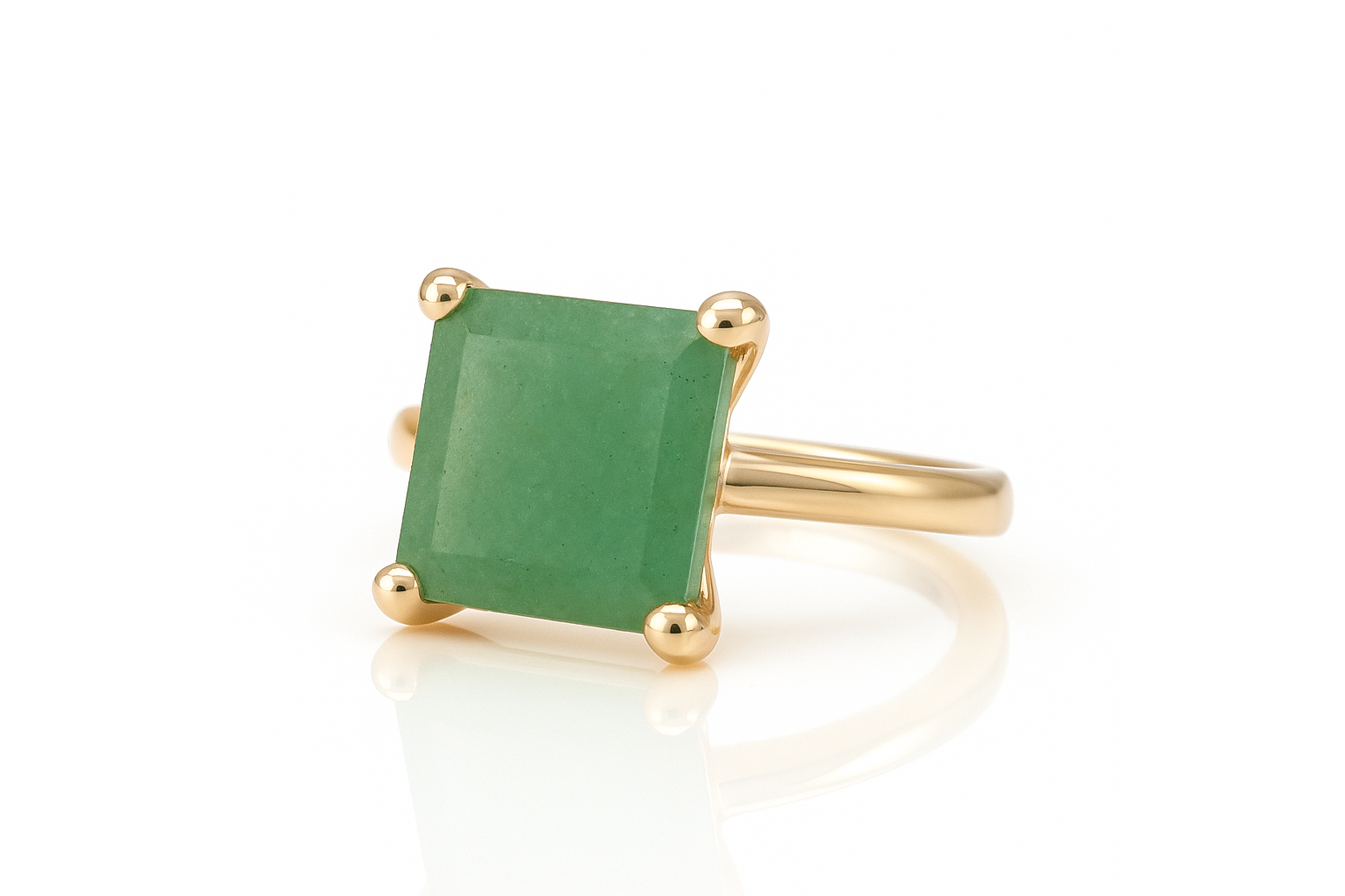 a gold ring with a green stone in it