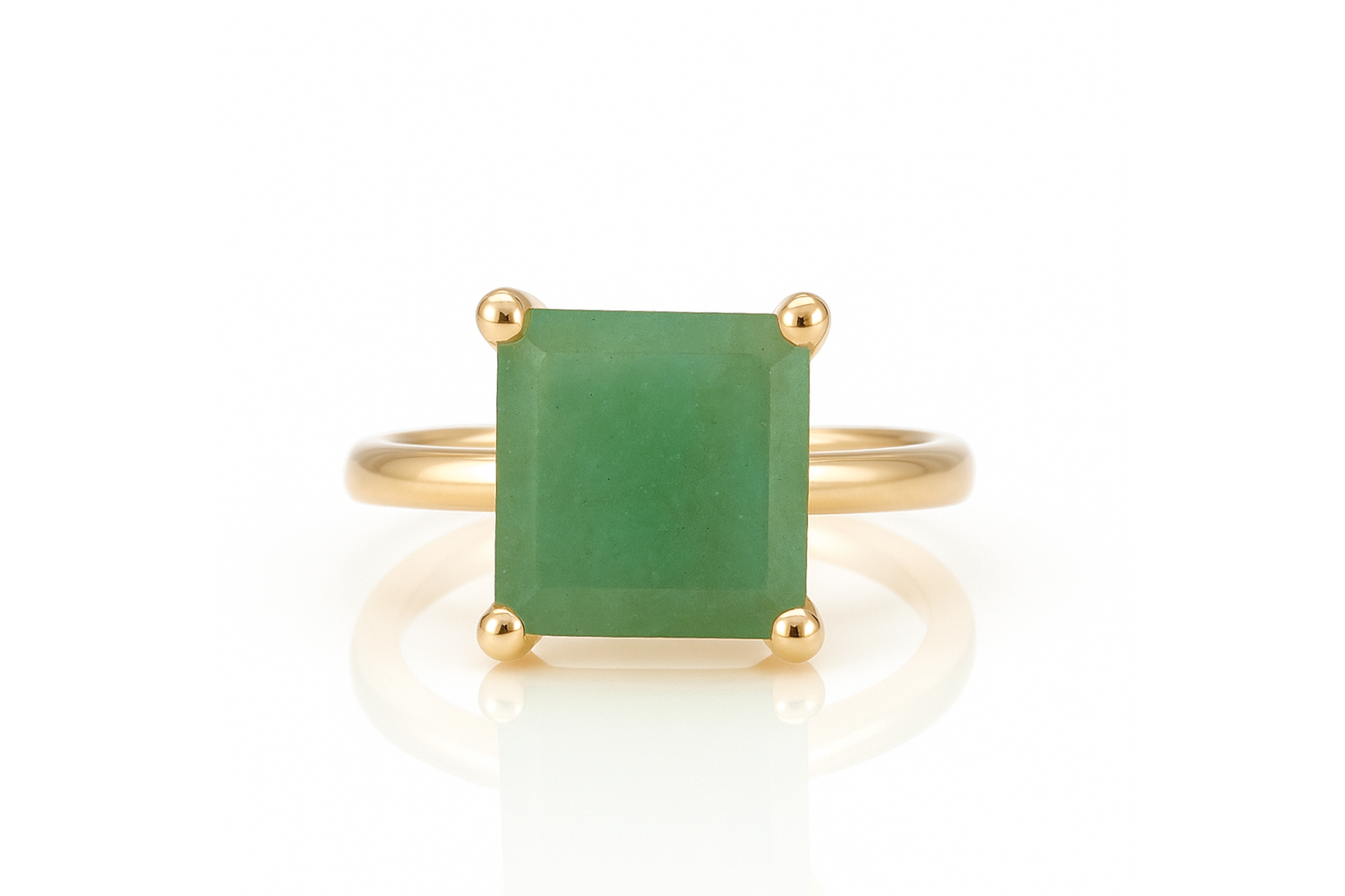 a gold ring with a green stone on it