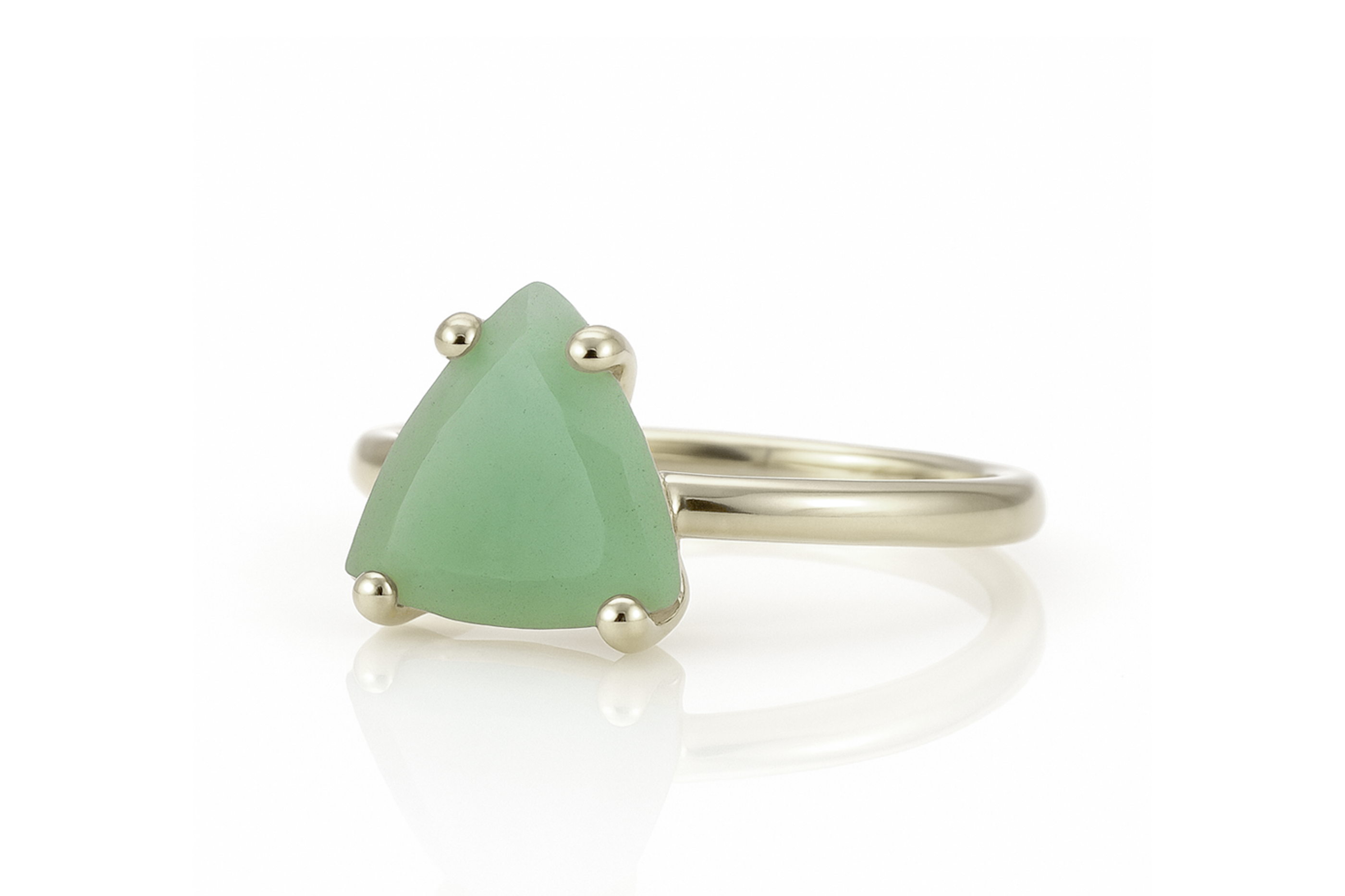 a close up of a ring with a green stone