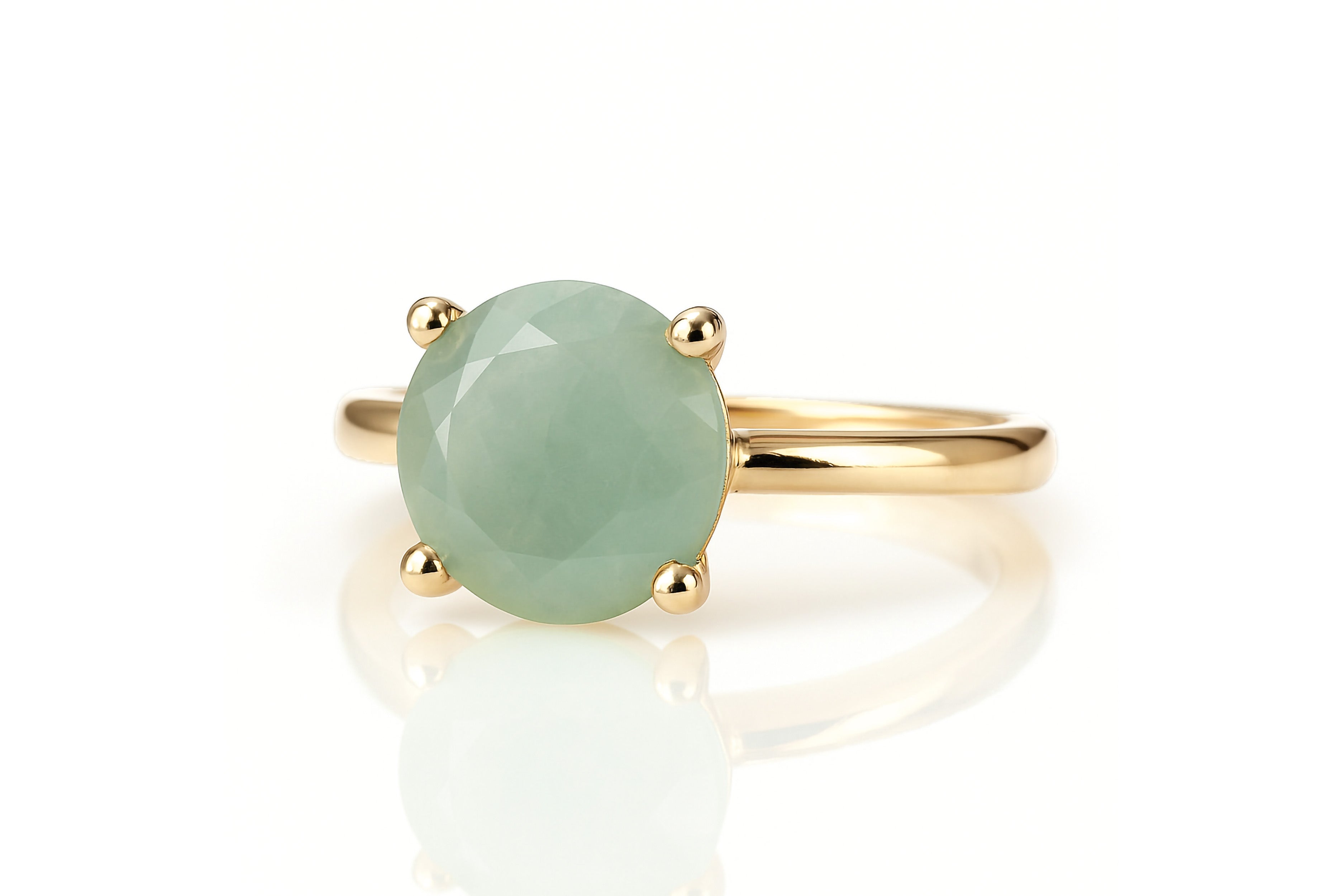 a ring with a green stone on top of it