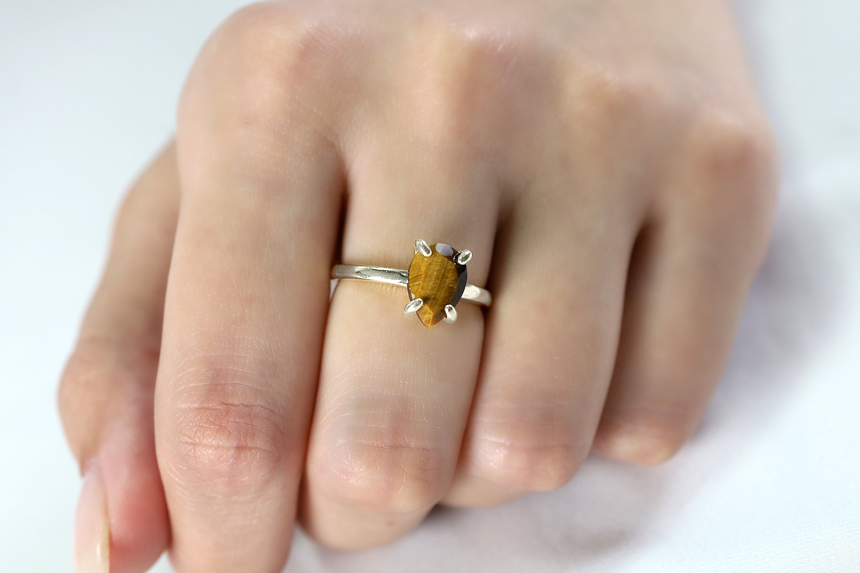 a close up of a person's hand with a ring on it