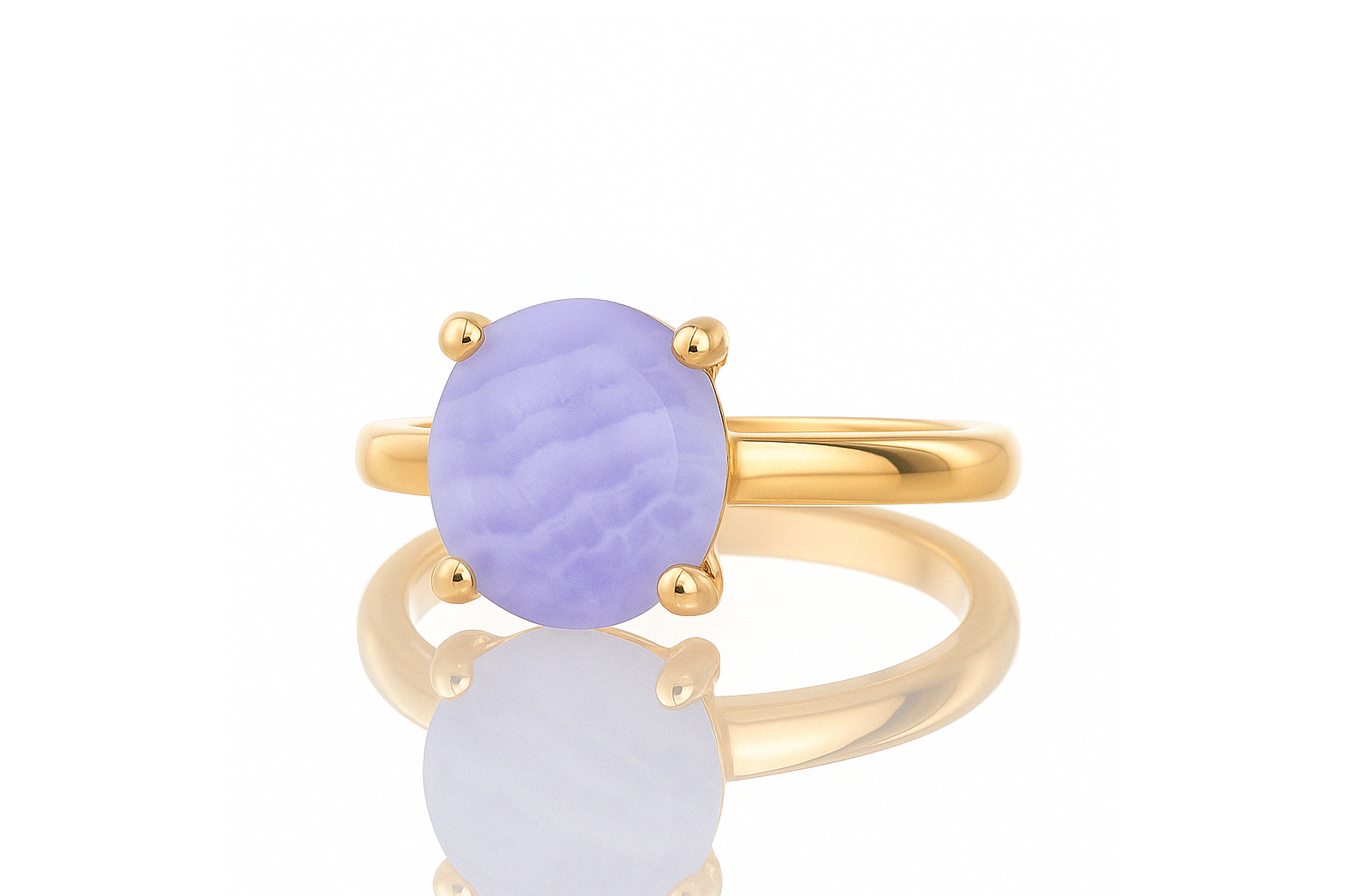 a yellow gold ring with a purple stone
