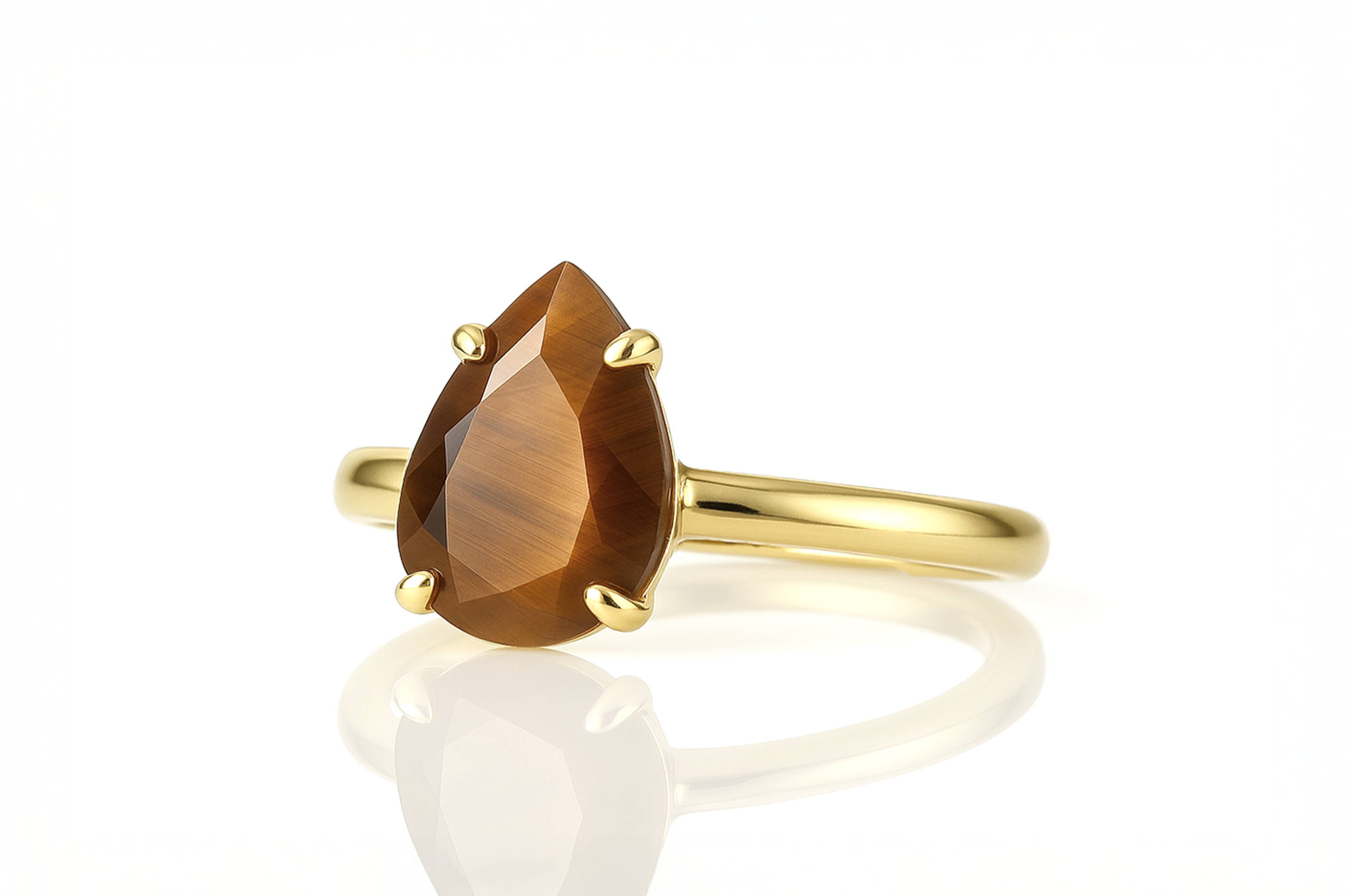 a yellow gold ring with a pear shaped brown stone
