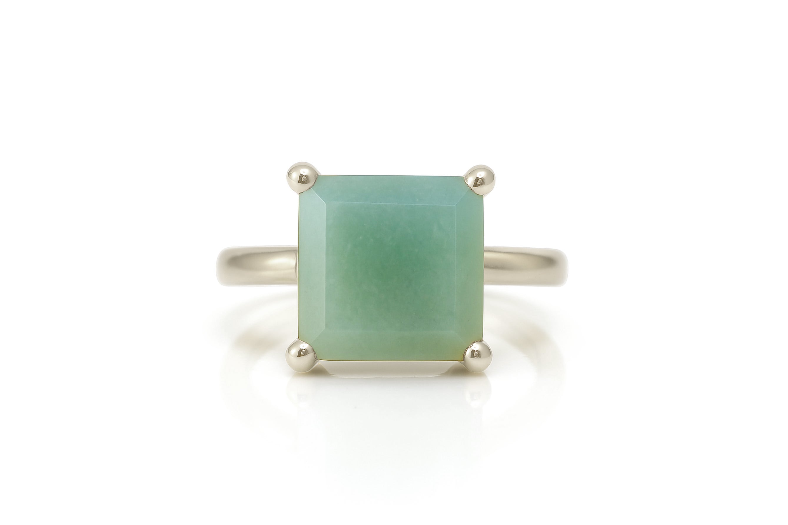 a ring with a green stone on it