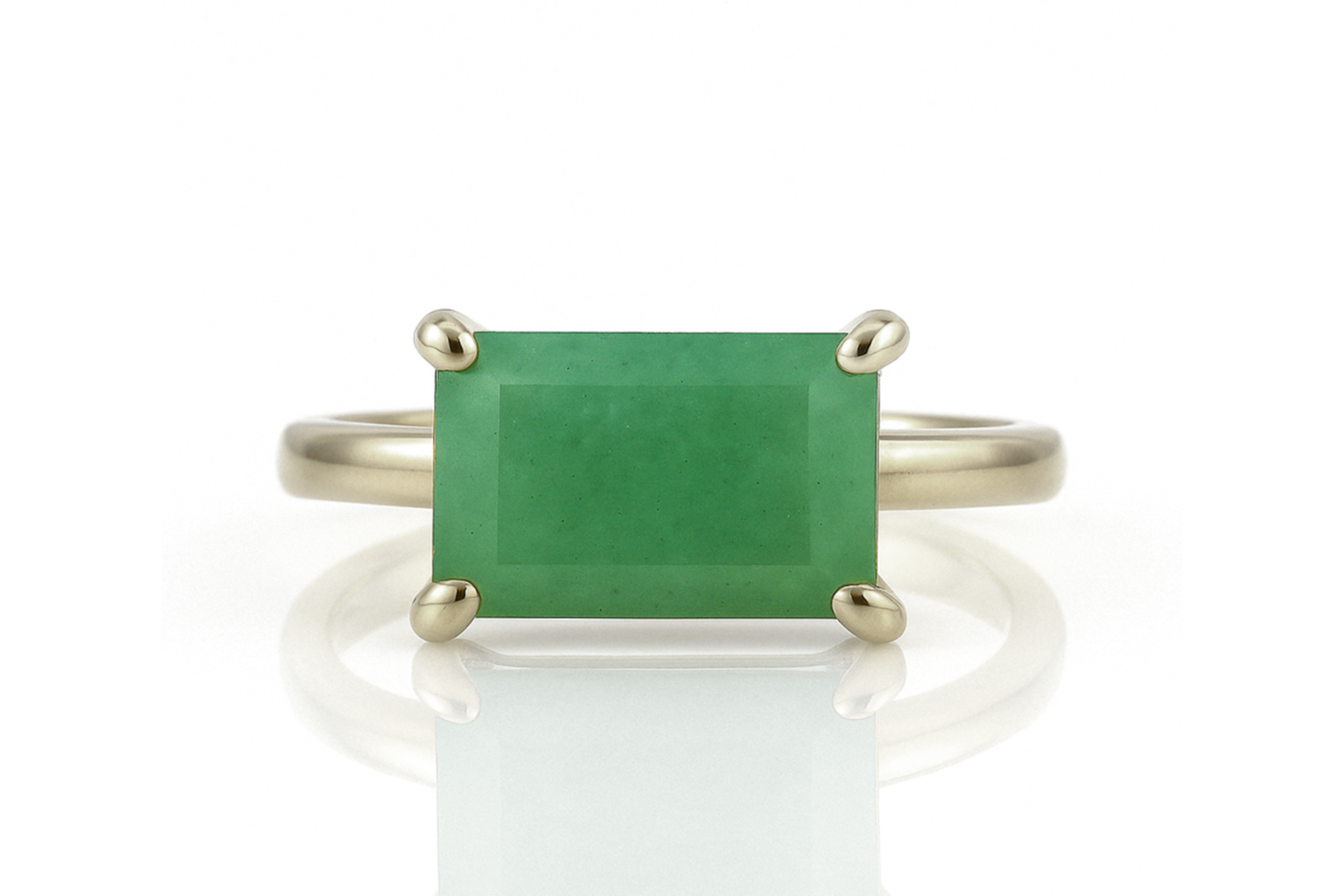a ring with a green stone on top of it