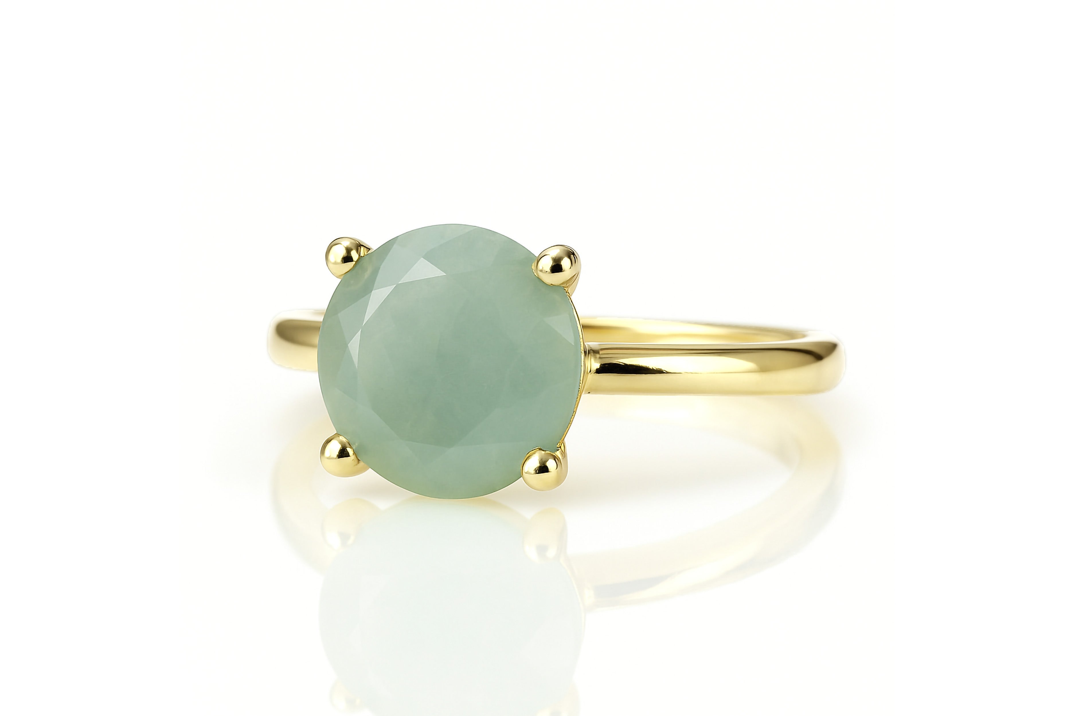 a ring with a large green stone on it