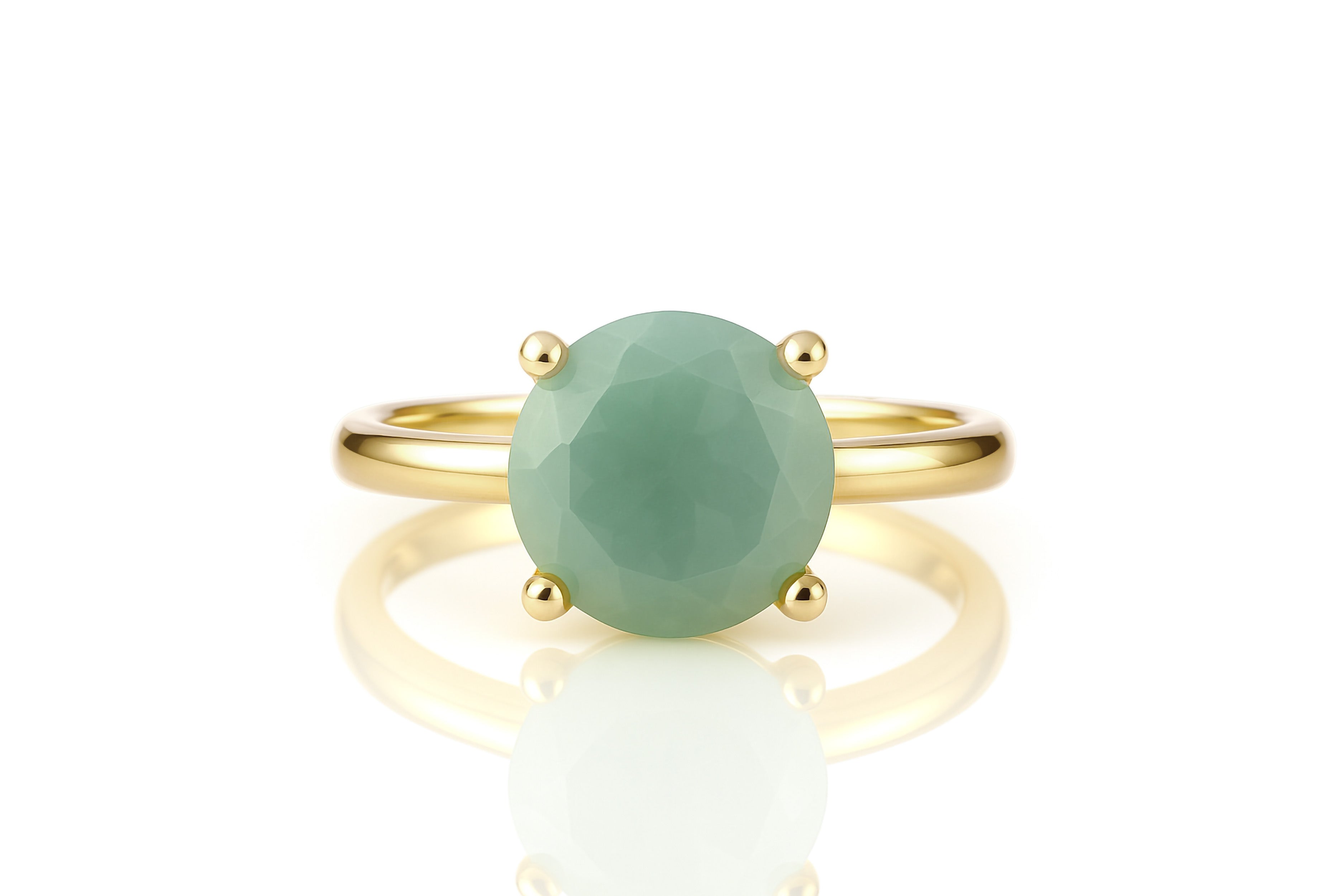 a gold ring with a green stone on it