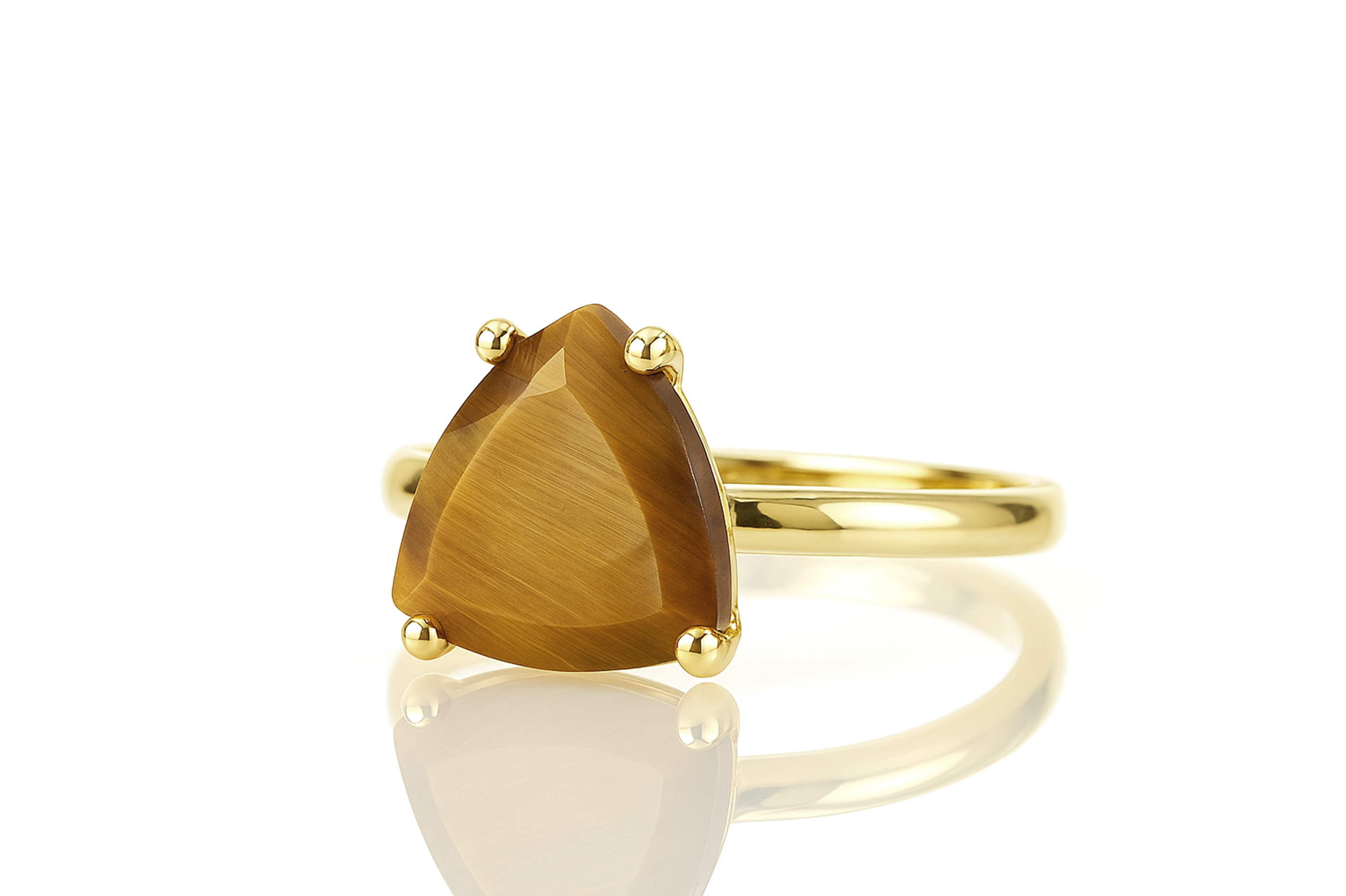 a yellow gold ring with a pear shaped stone