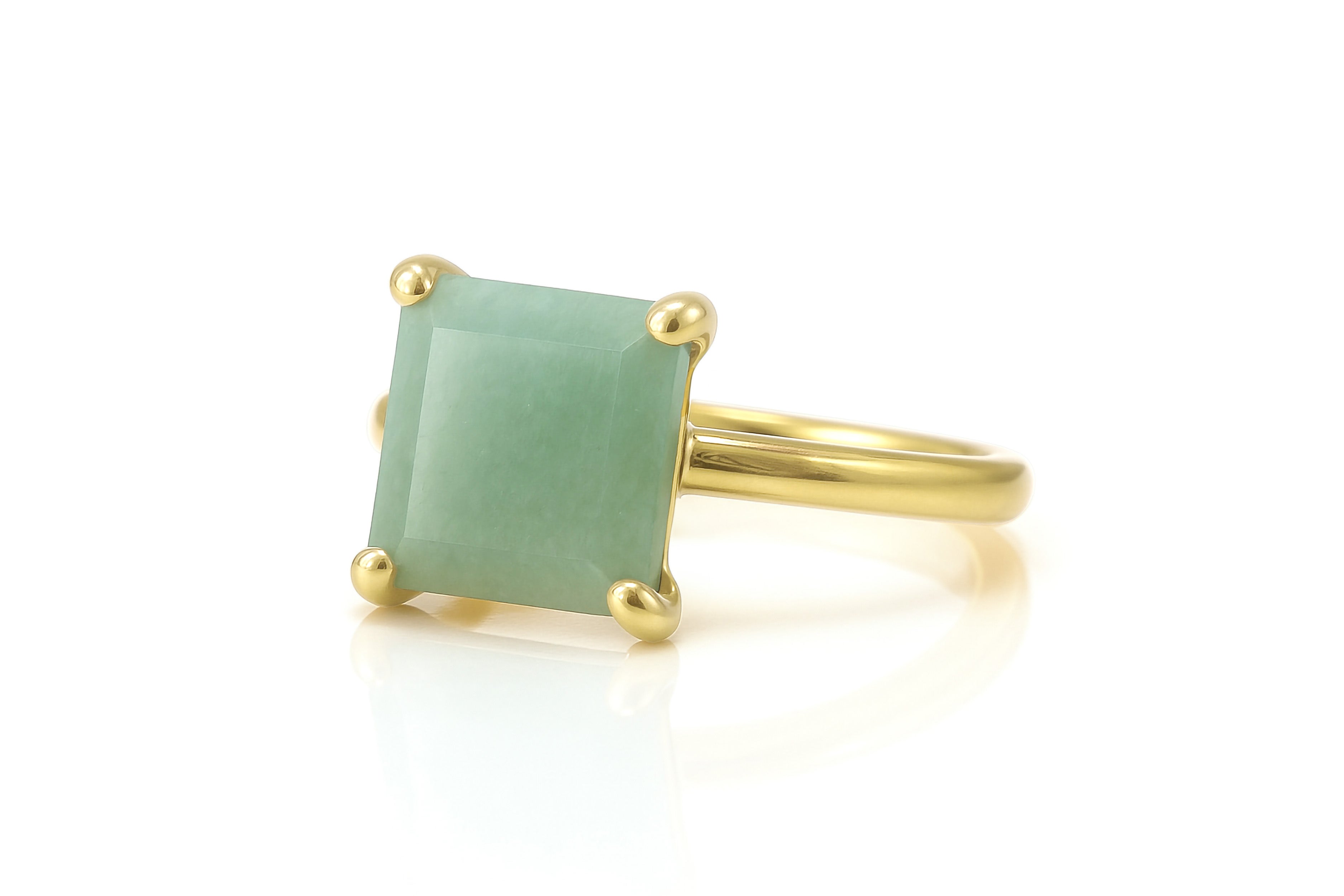 a gold ring with a green stone on it