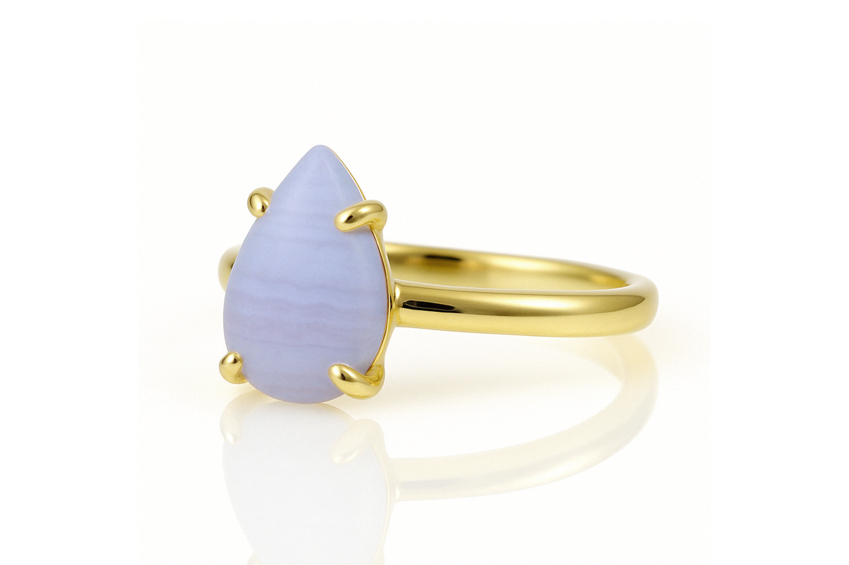 a yellow gold ring with a blue stone
