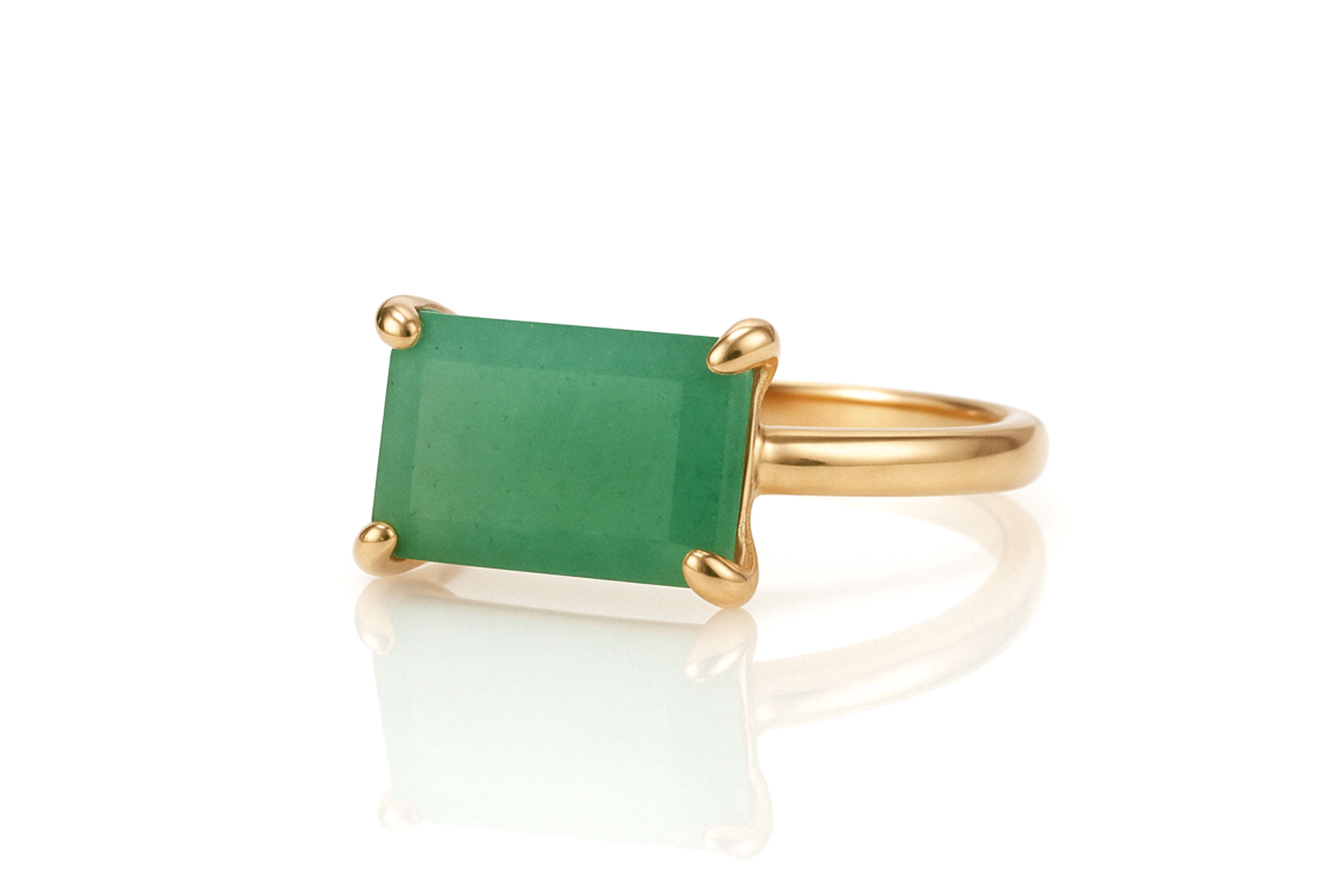 a gold ring with a green stone on it