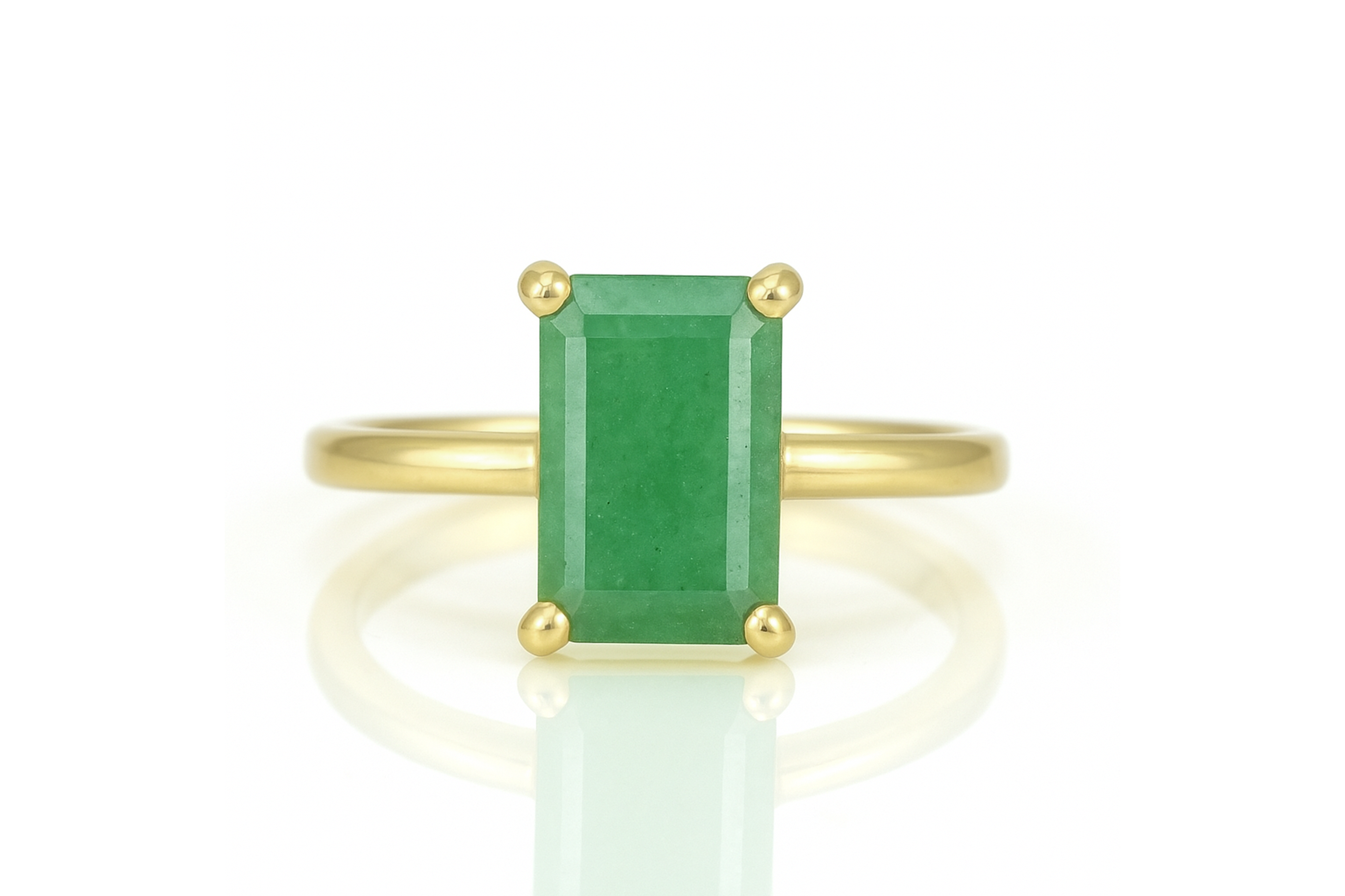 a ring with a green stone on top of it