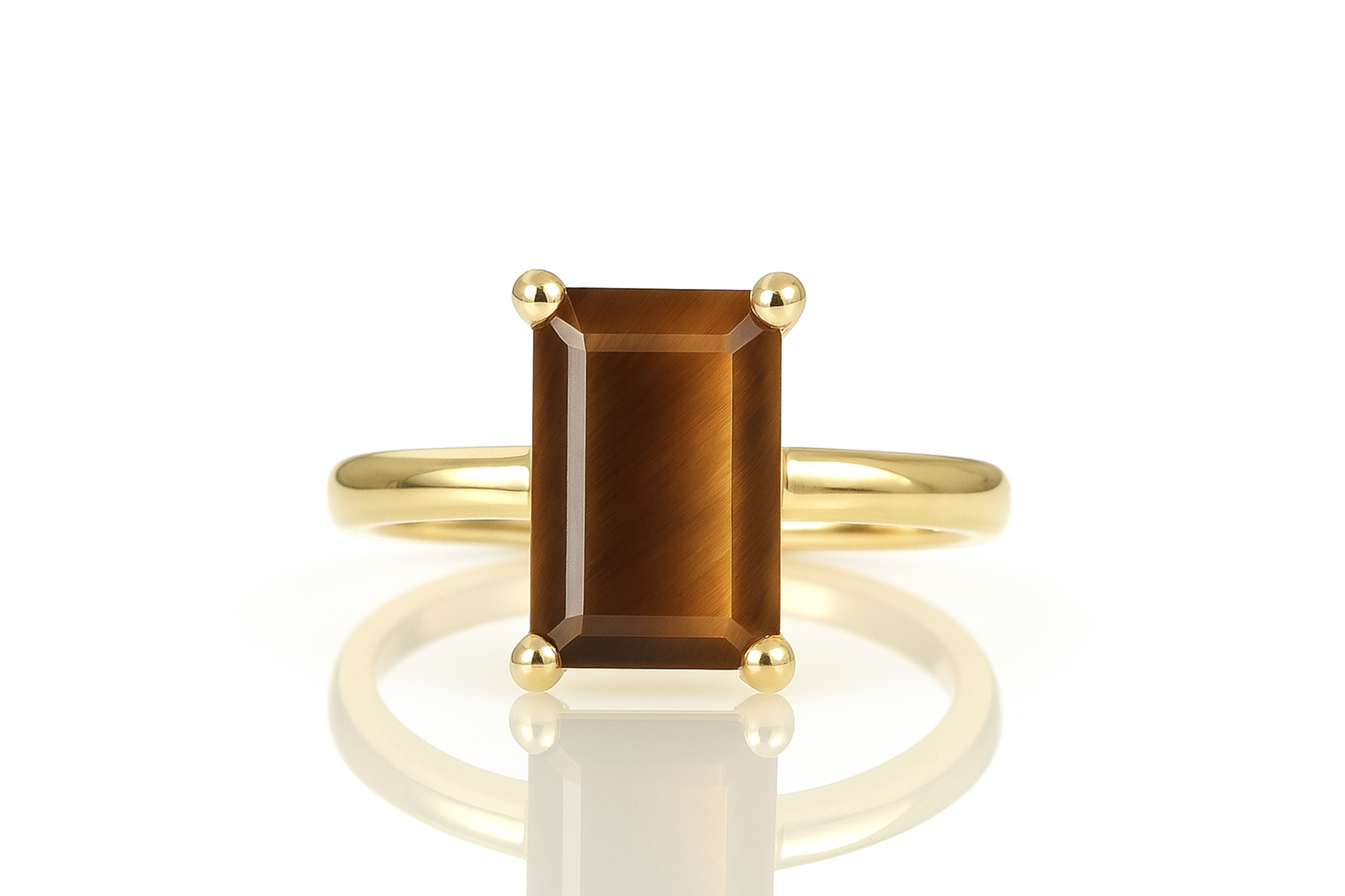 a yellow gold ring with a brown stone