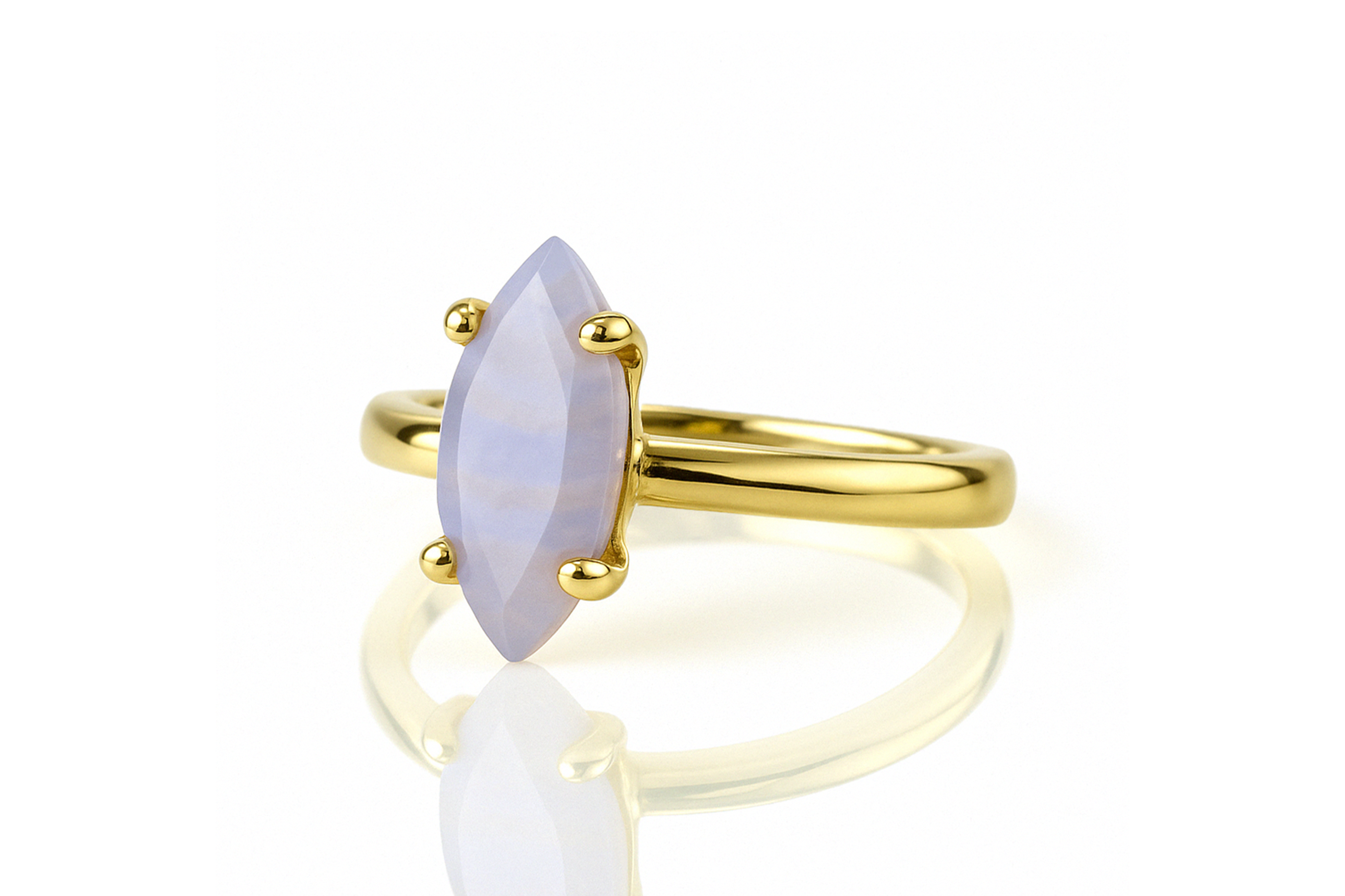 a yellow gold ring with a white stone