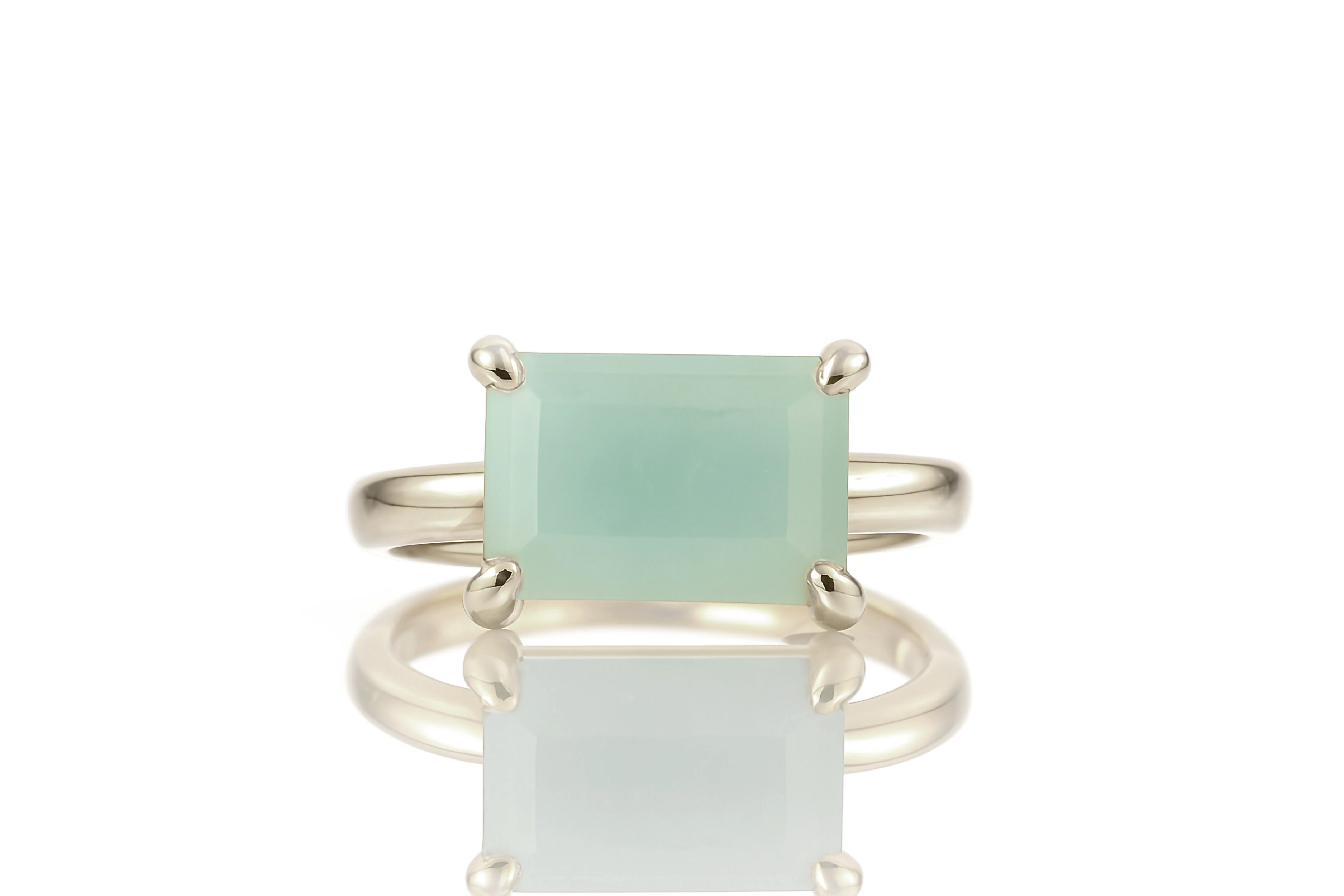 a ring with a green stone on top of it