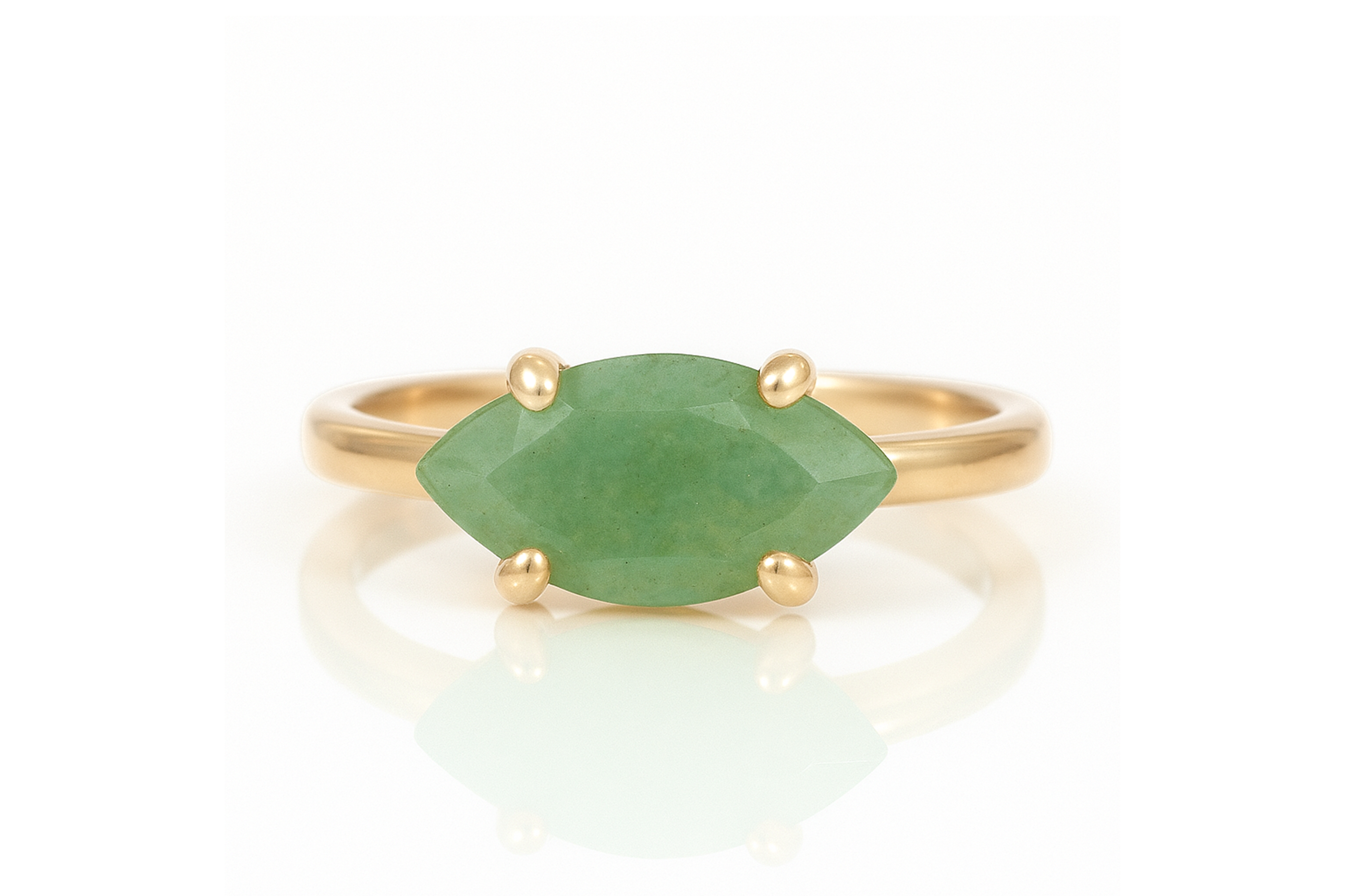 a gold ring with a green stone on it