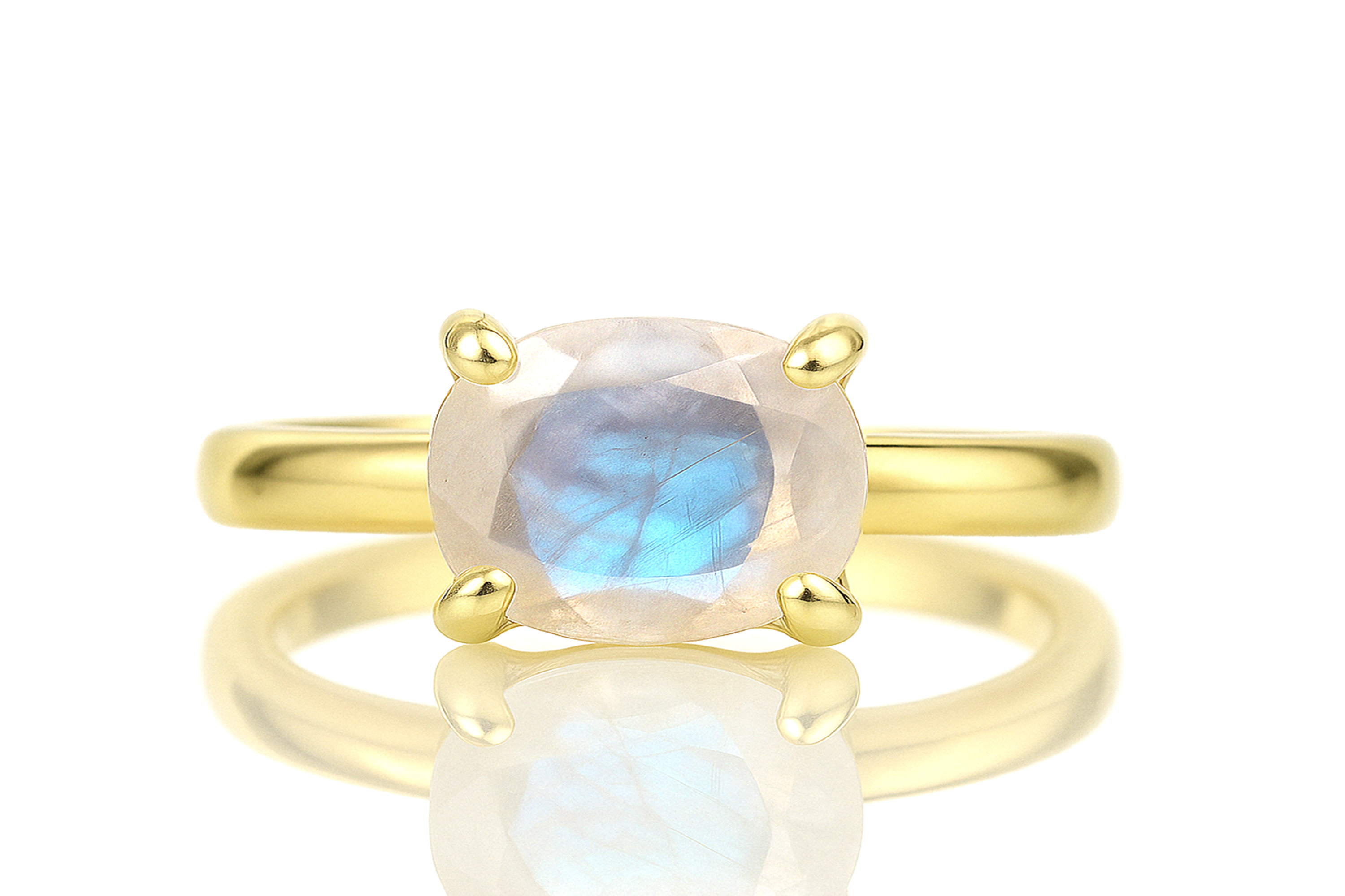 a yellow gold ring with a blue and white stone