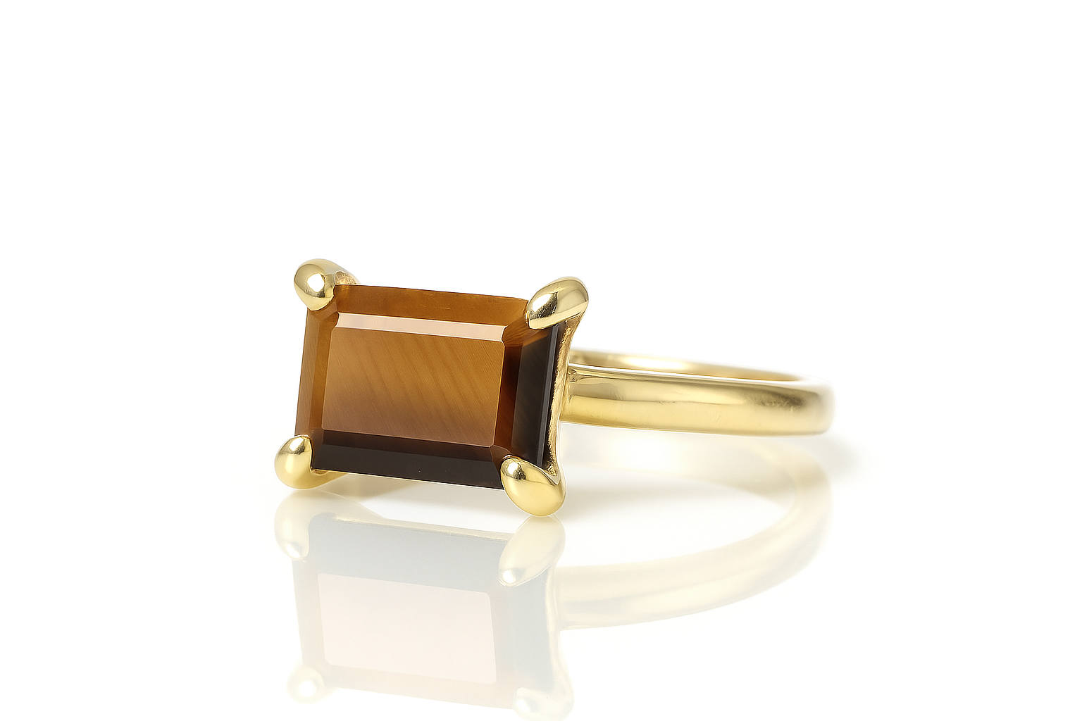 a yellow gold ring with a brown stone