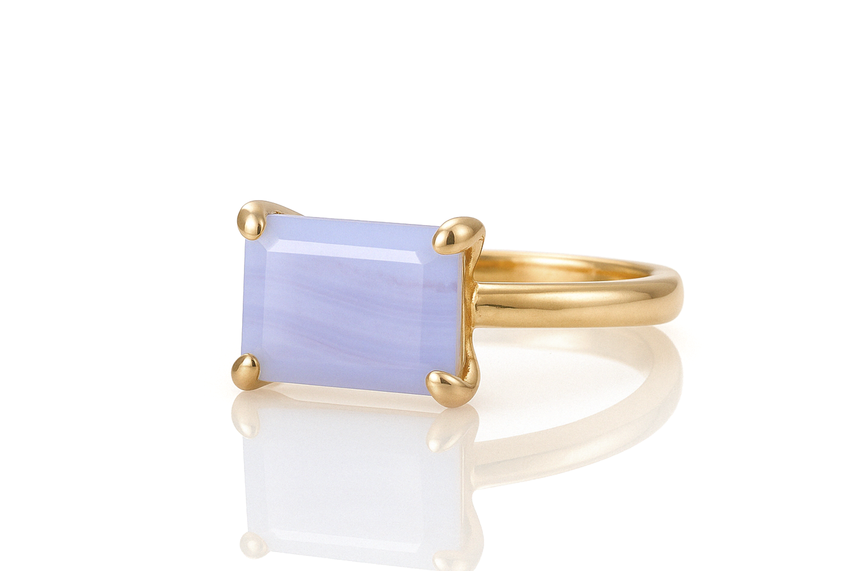 a yellow gold ring with a blue stone