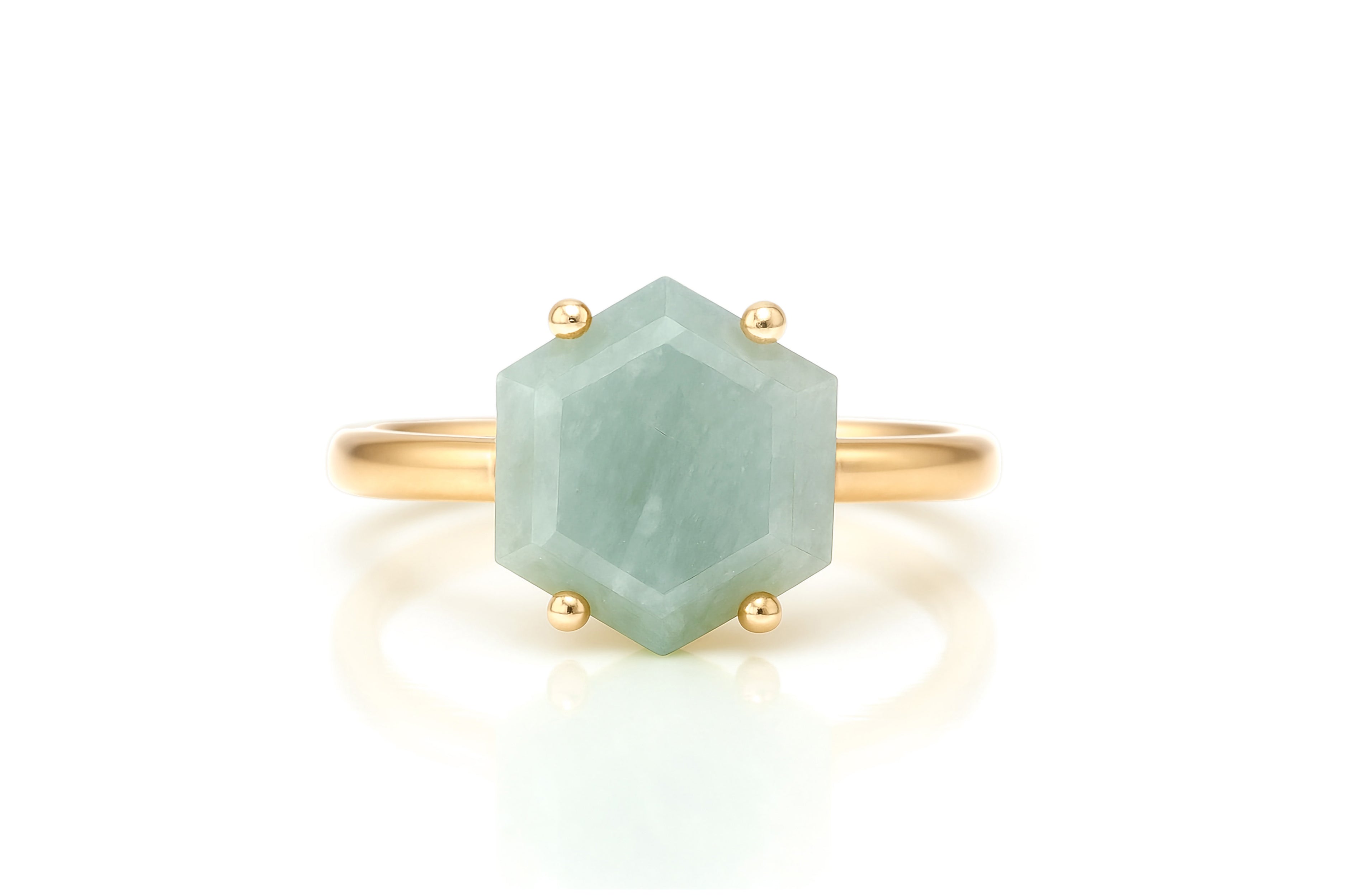 a gold ring with a green stone on it