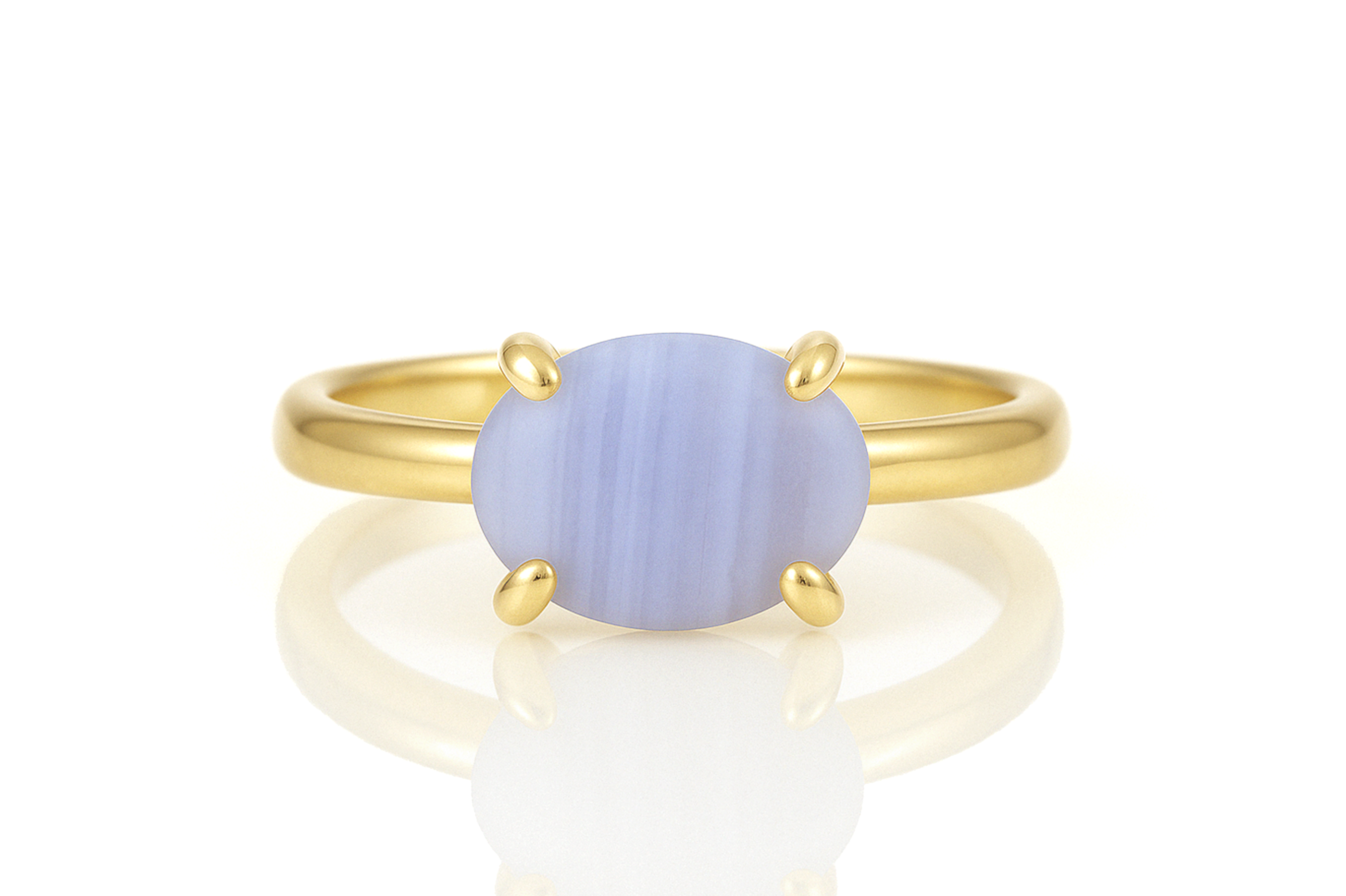 a yellow gold ring with a blue stone