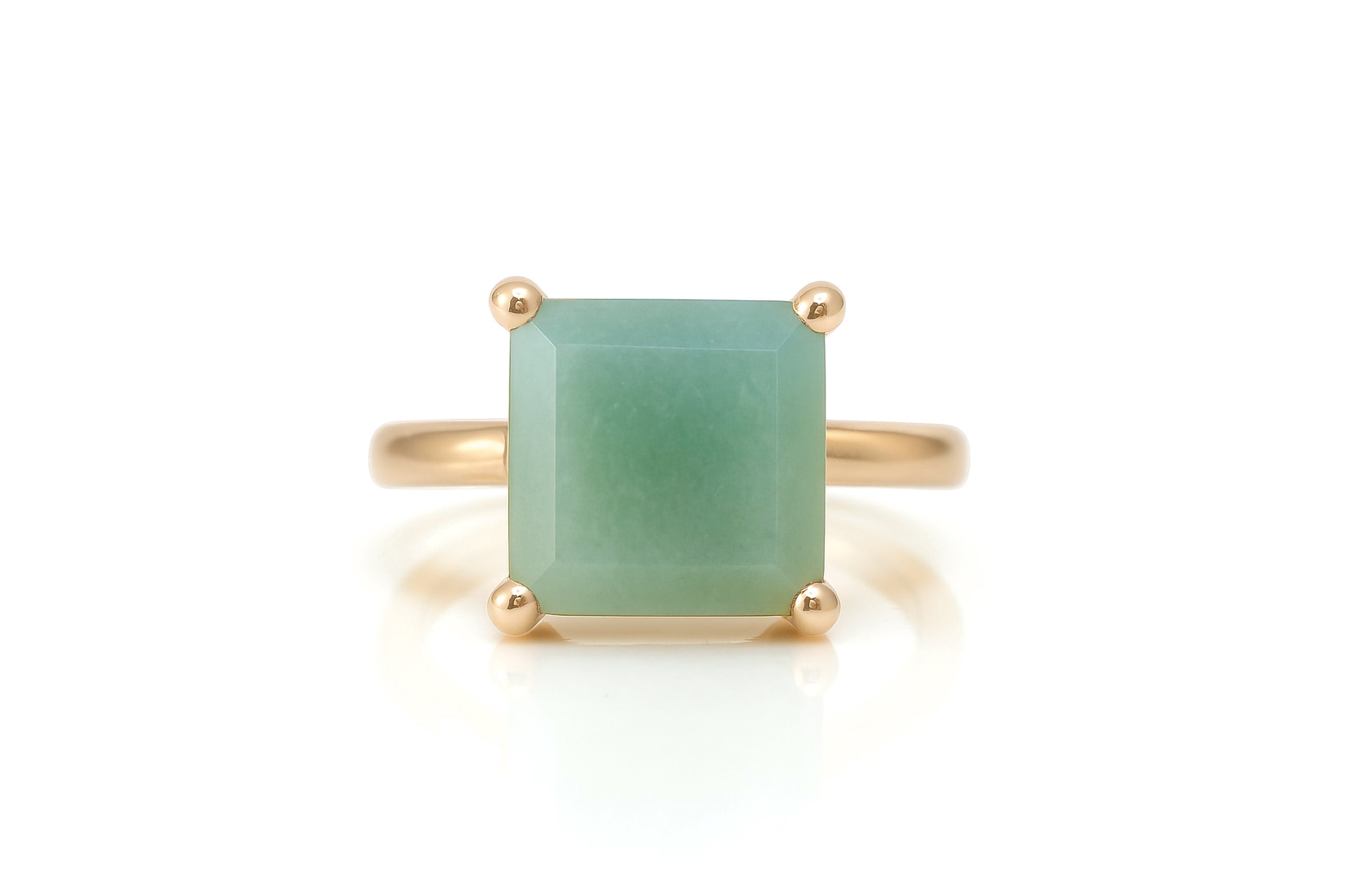 a gold ring with a green jade stone