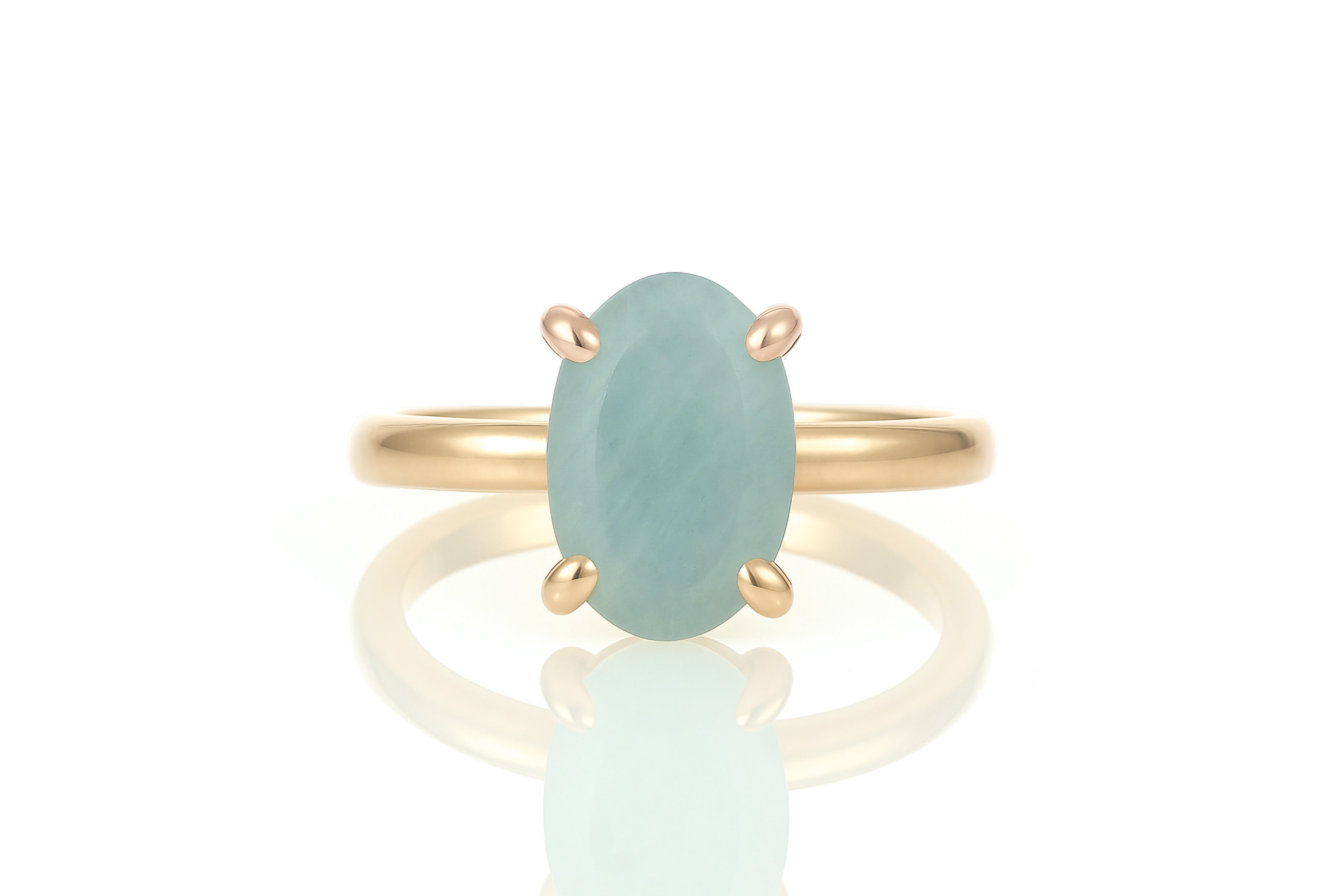 a gold ring with a blue stone on it