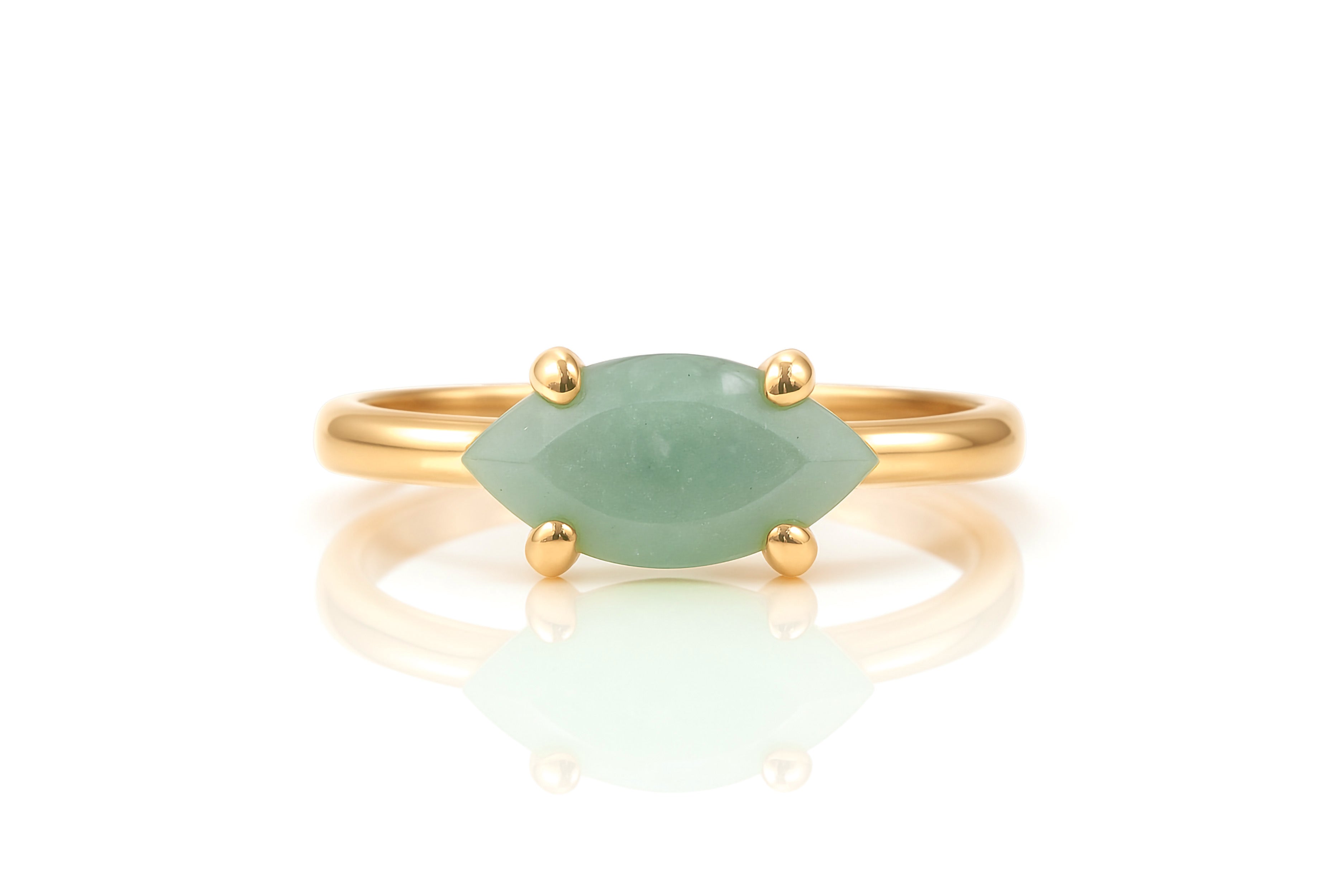 a gold ring with a green stone on it