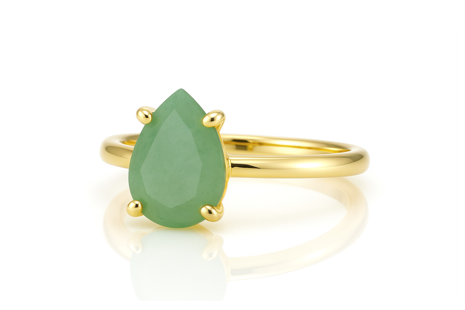 a yellow gold ring with a pear shaped green stone