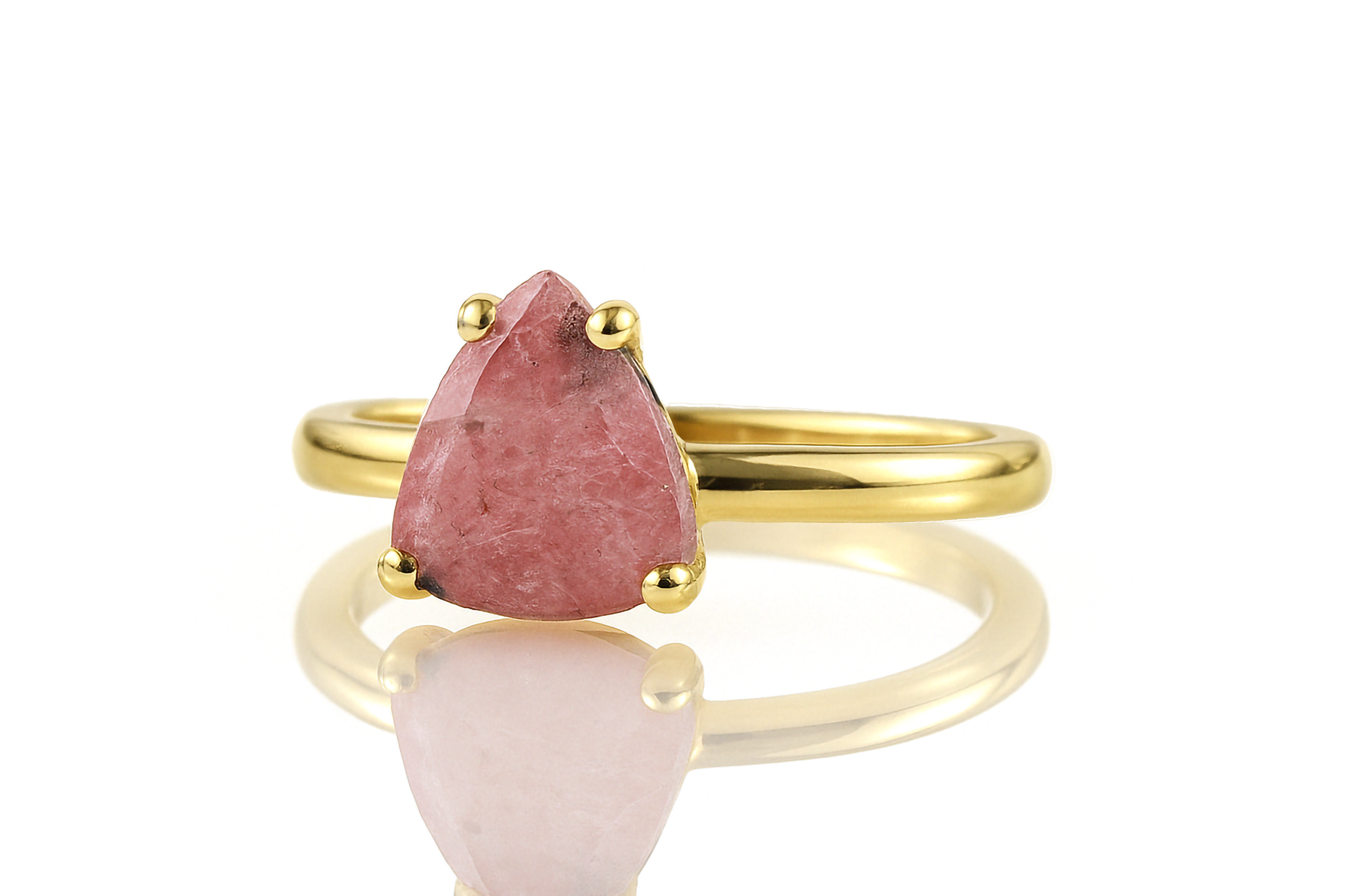 a gold ring with a pink stone on it