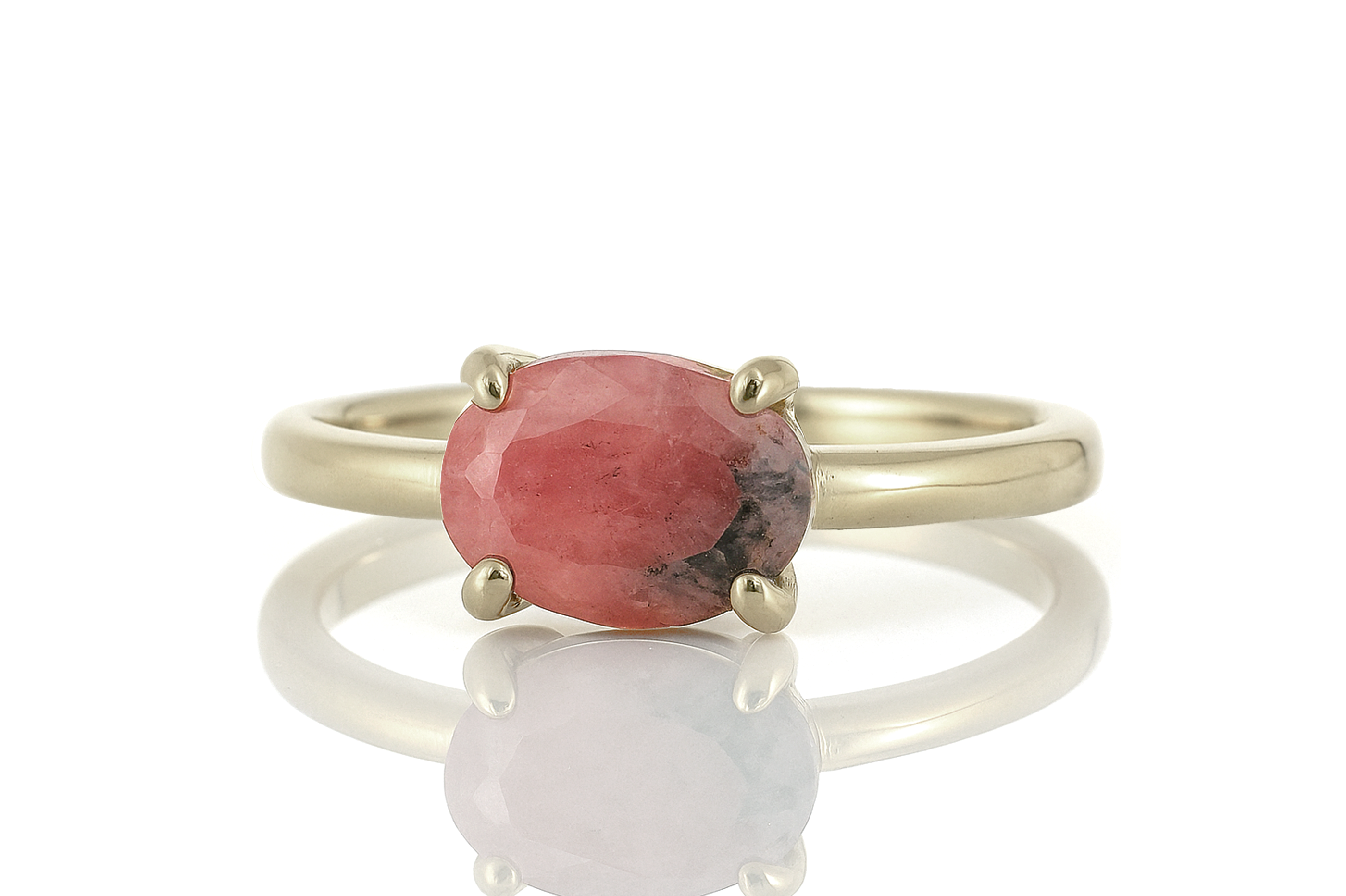 a gold ring with a red stone on it